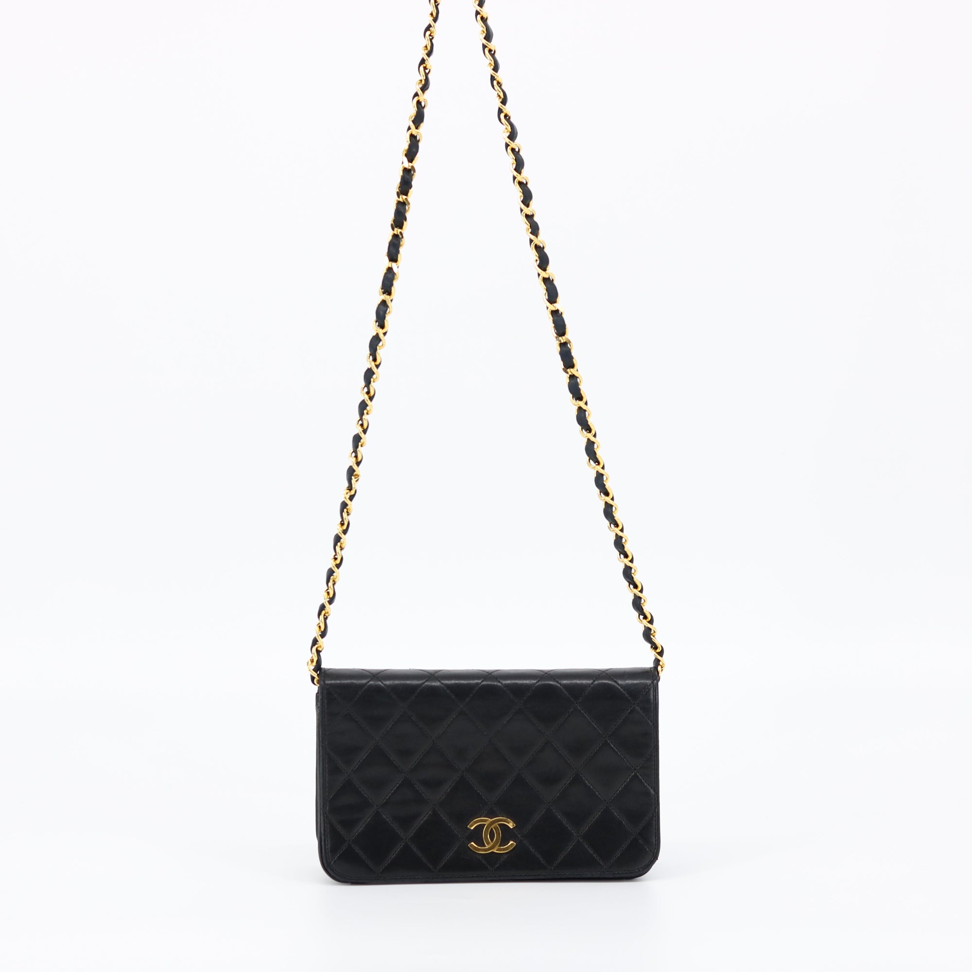 Chanel Black Quilted Lambskin bag, photographed against soft cream backdrop
