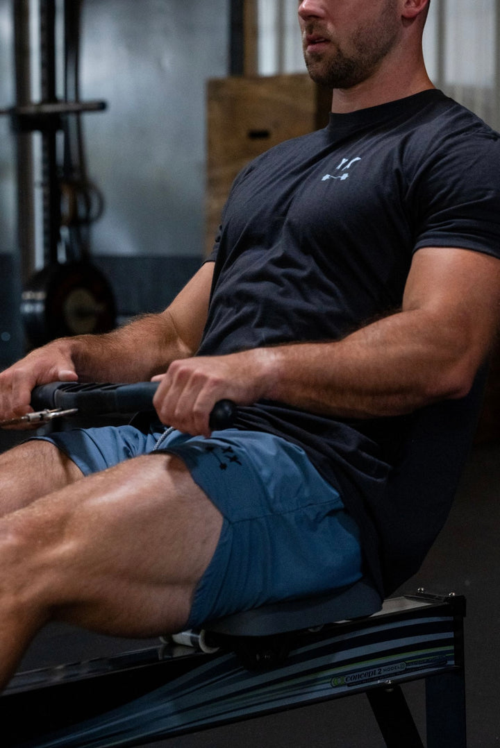 BLACKOUT BARBELL athlete loading a barbell — progressive overload at work