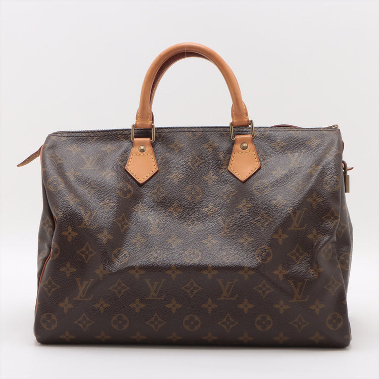 Authentic Louis Vuitton Speedy 35 Monogram Canvas, close-up of leather handles and brass hardware