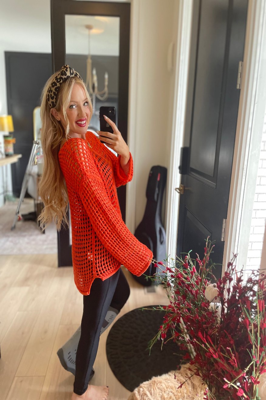 Pretty Little Patriot Pretty Little Patriot Orange Open Knit Sweater — Pretty Little Patriot branding close-up