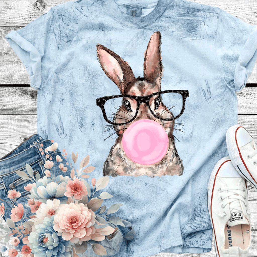 A Blessed Texas Mess Boutique Comfort Color Colorblast Tie Dye Fun Bubble Blowing Bunny — graphic shirts category context