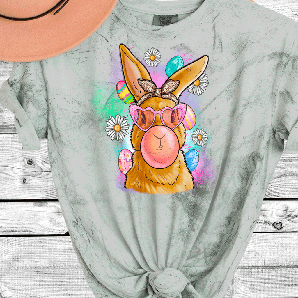 A Blessed Texas Mess Boutique Comfort Color Colorblast Tie Dye Fun Bubble Blowing Bunny — graphic shirts category context