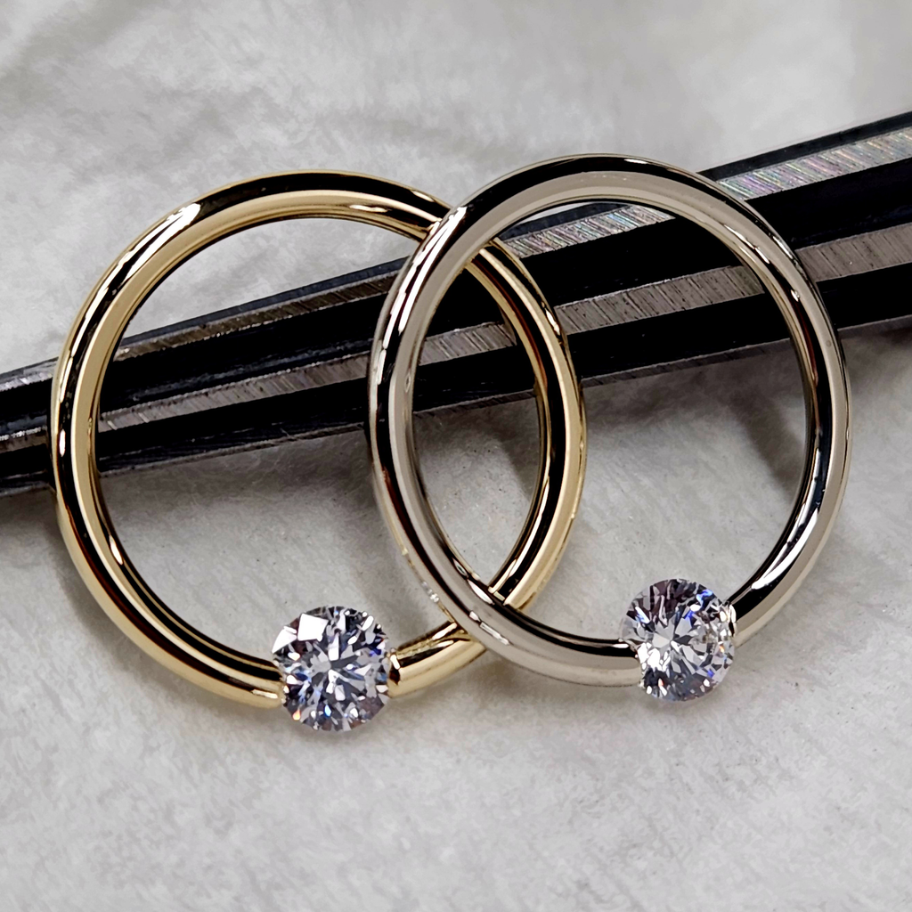 BodyCandy 16G 3/8 Solid 14k Yellow Gold 3mm Clear Cubic Zirconia Tension Captive Ring — in-use photo
