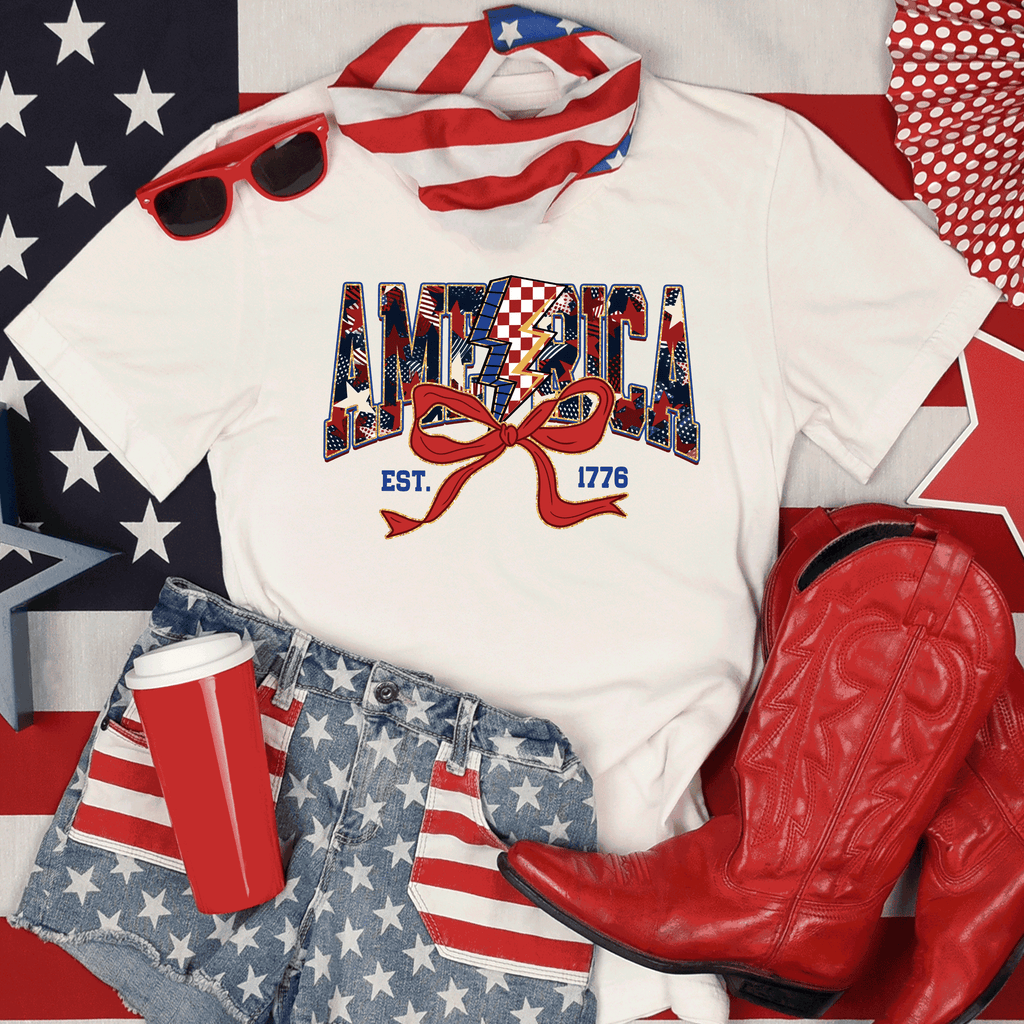 A Blessed Texas Mess Boutique America Est 1776, Checkered Lightning Bolt, 4th of july Coquette Bow Land of… — main product shot
