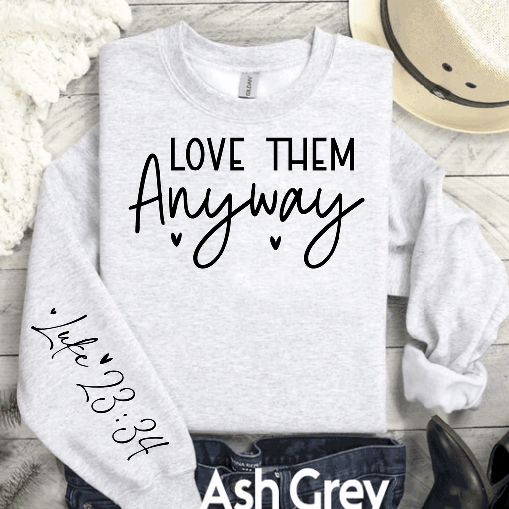 A Blessed Texas Mess Boutique Love Them Anyway Sweatshirt, Christian Luke 23:34 Sweatshirt, Kindness… — A Blessed Texas Mess Boutique branding close-up