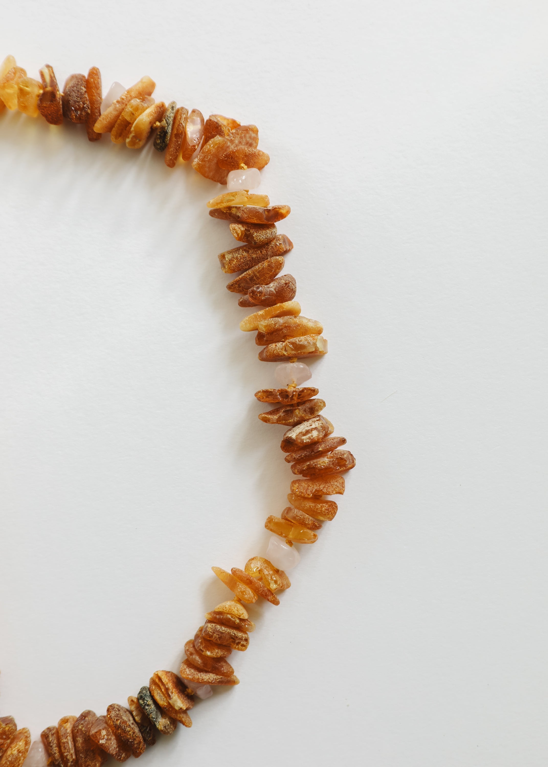 CanyonLeaf Pet Necklace: Raw Baltic Amber + Raw Rose Quartz — detail close-up