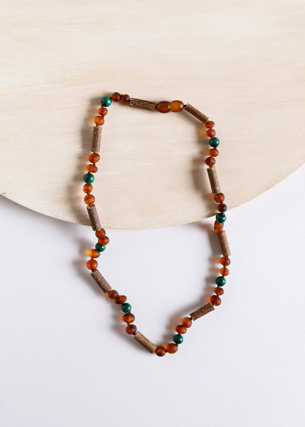 CanyonLeaf Hazelwood || Raw Cognac Baltic Amber + Malachite || Necklace — CanyonLeaf branding close-up