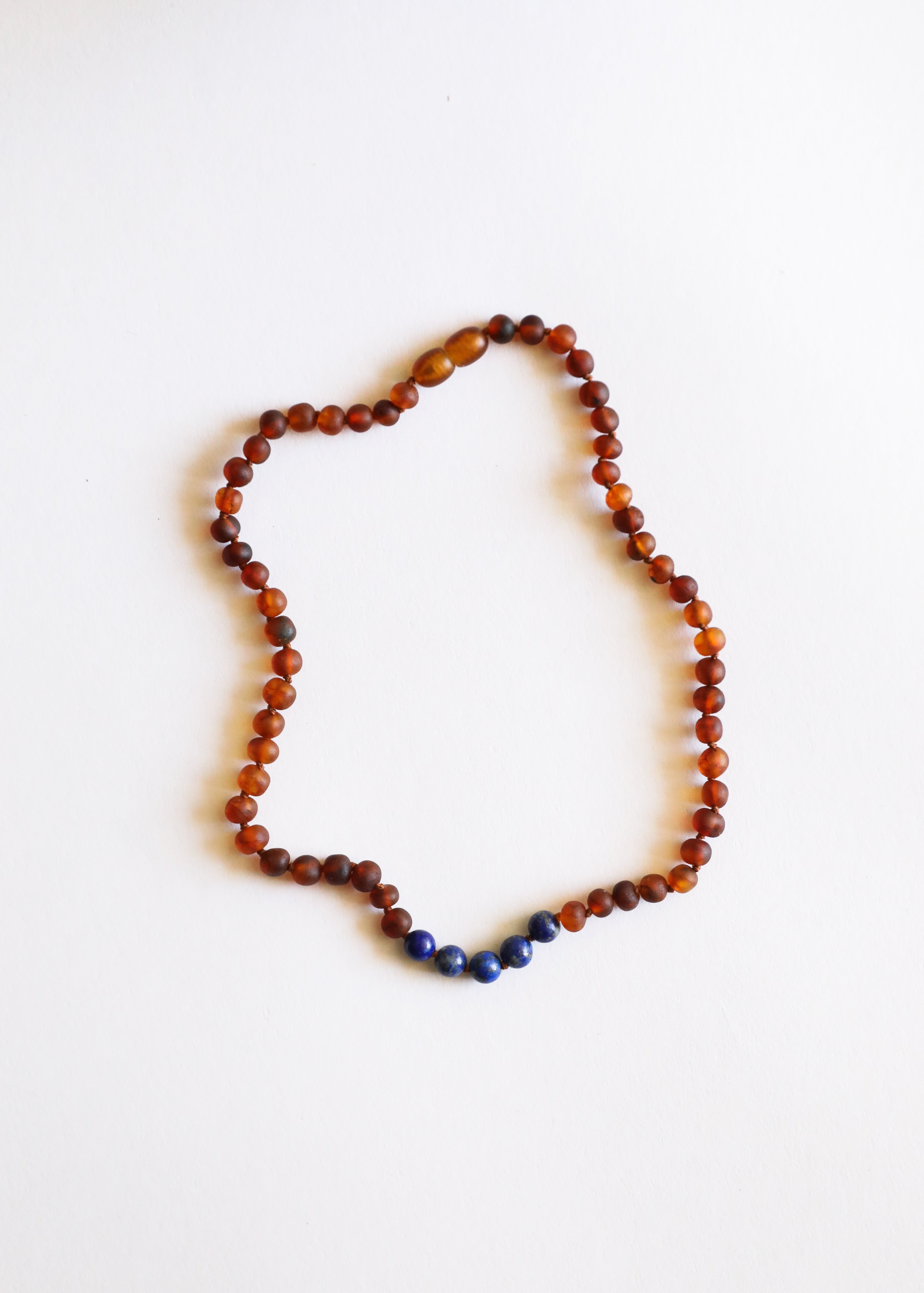 CanyonLeaf Raw Cognac Baltic Amber + Lapis Stone Necklace — lifestyle context