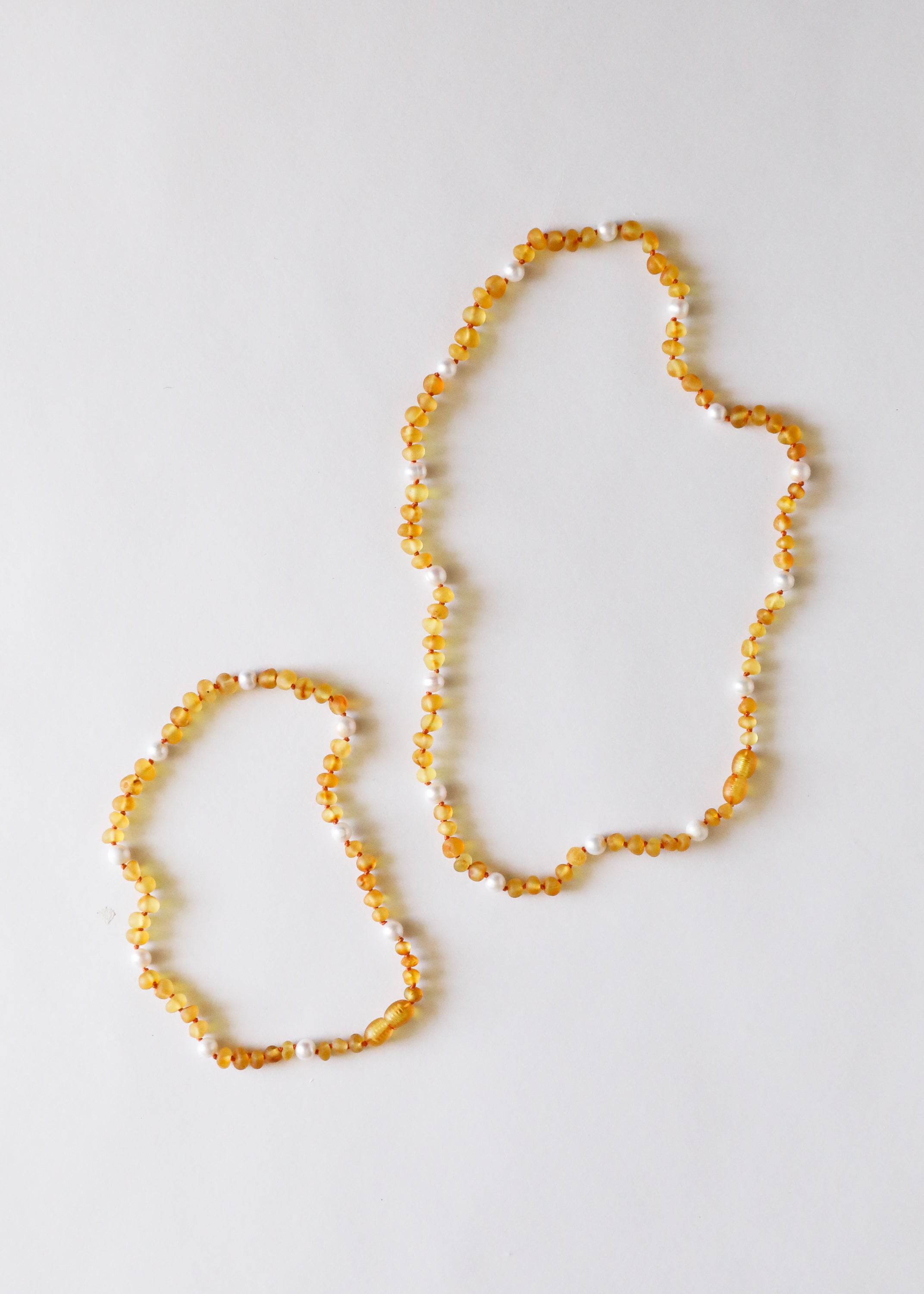 CanyonLeaf Raw Honey Baltic Amber + Pearl Halo || Necklace — CanyonLeaf branding close-up