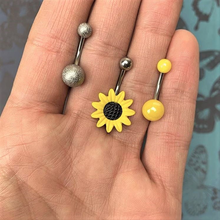 BodyCandy Sandblasted and Yellow UV Glow Sunflower Belly Ring Set of 3 — detail close-up