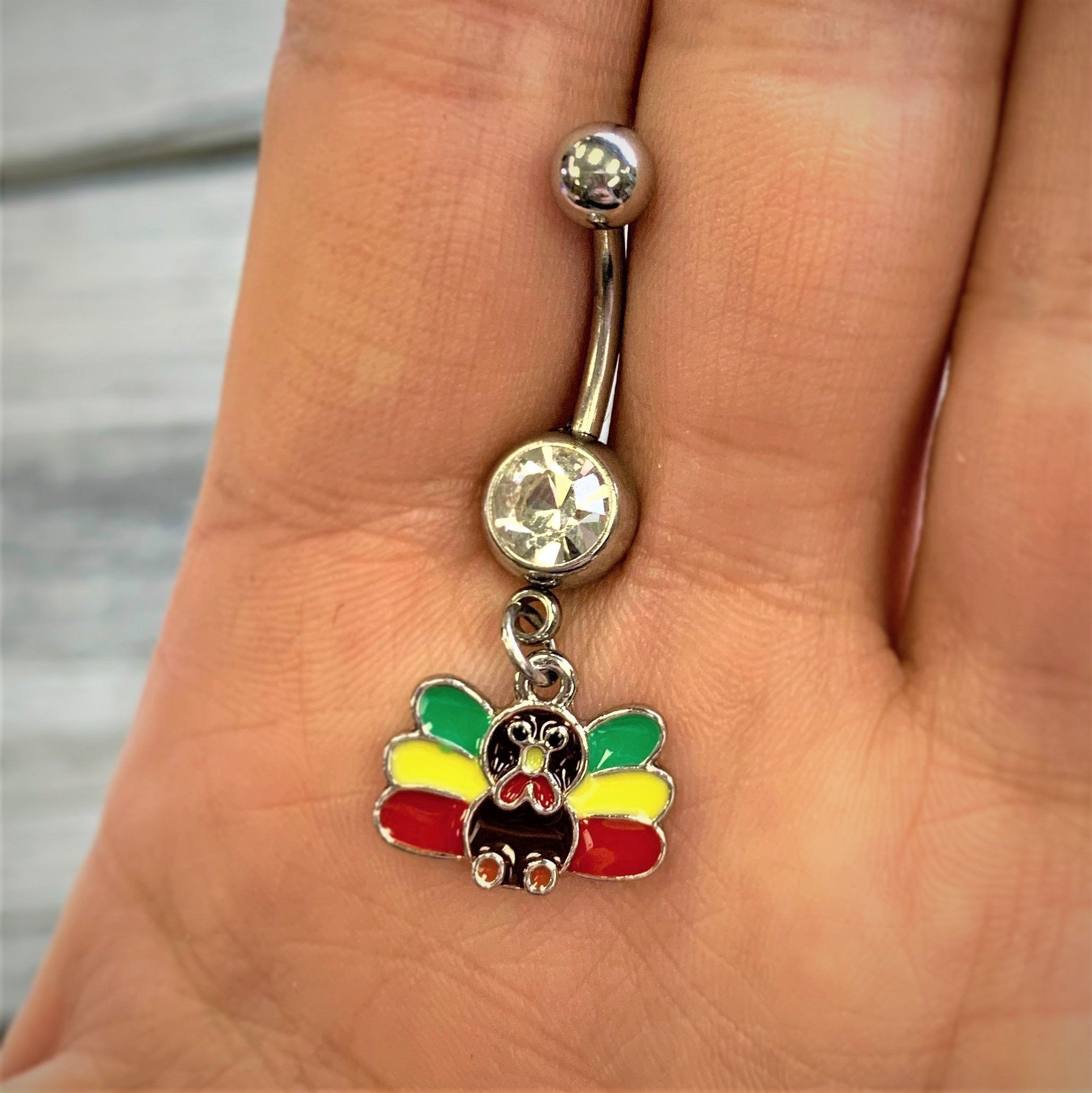 BodyCandy Clear Gem Red Green Rasta Thanksgiving Turkey Dangle Belly Ring — detail close-up