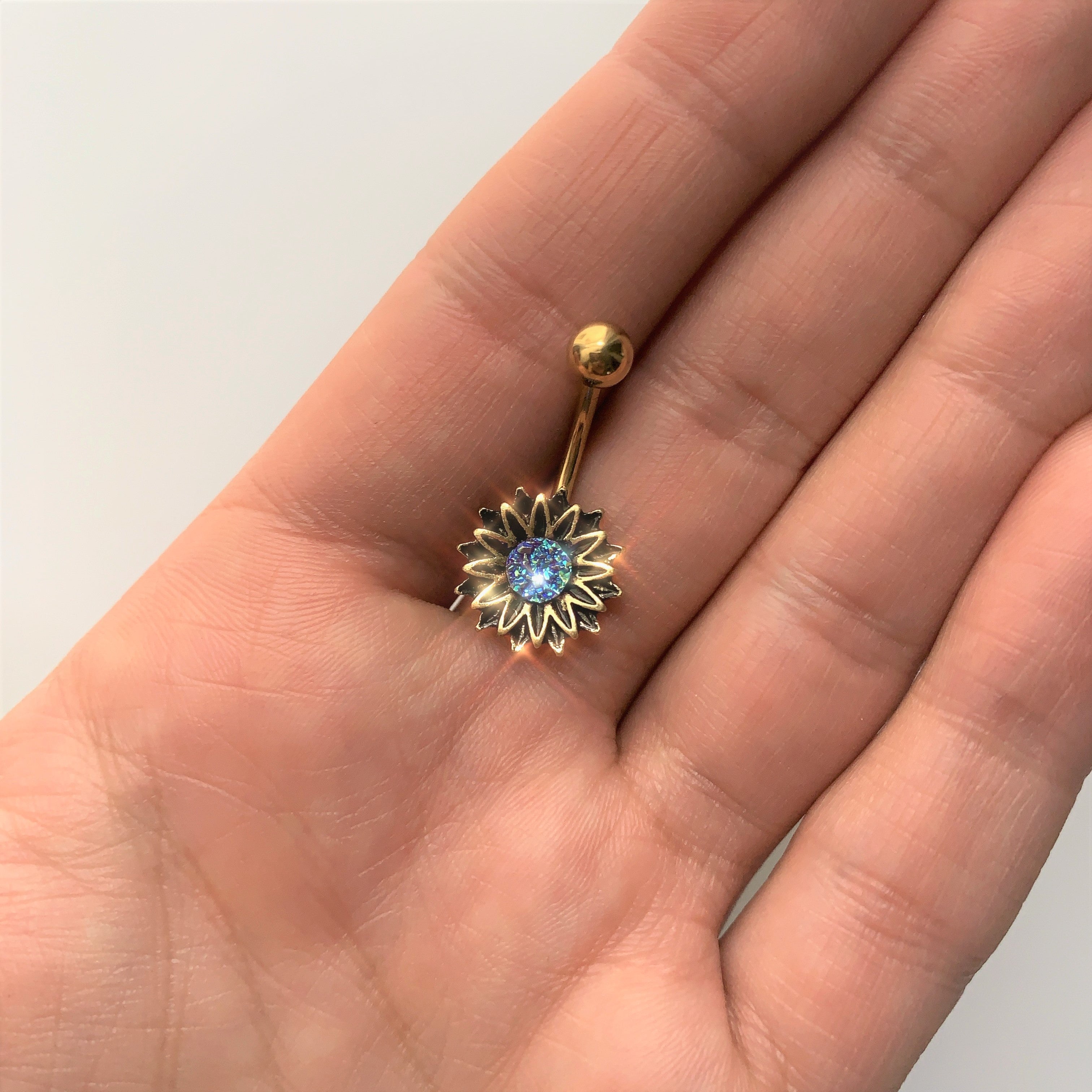 BodyCandy Gold Tone Aqua Center Sunburst Flower Belly Ring — lifestyle context