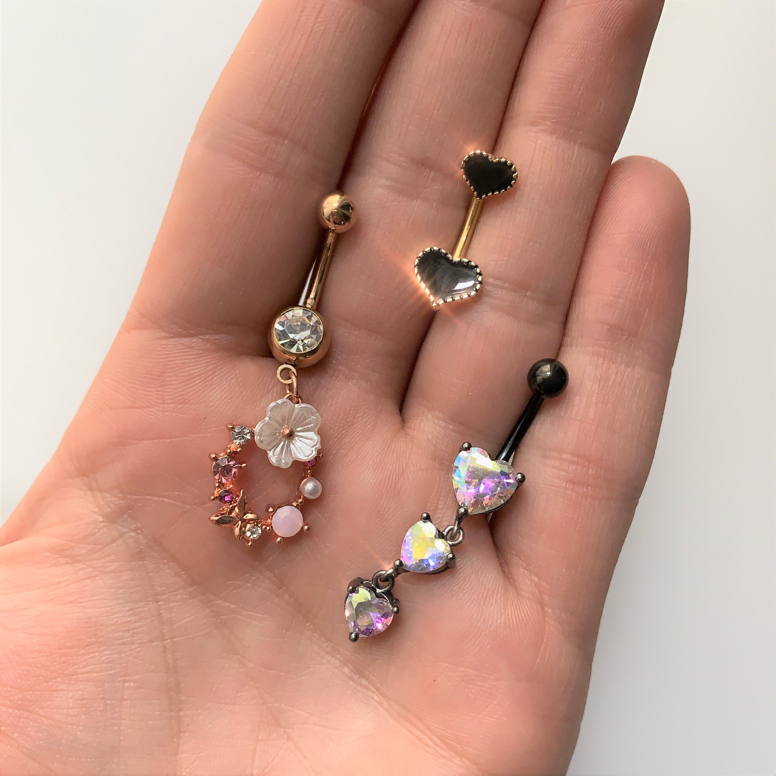 BodyCandy Aurora CZ Gem Black Triple Heart Dangle Belly Ring — detail close-up