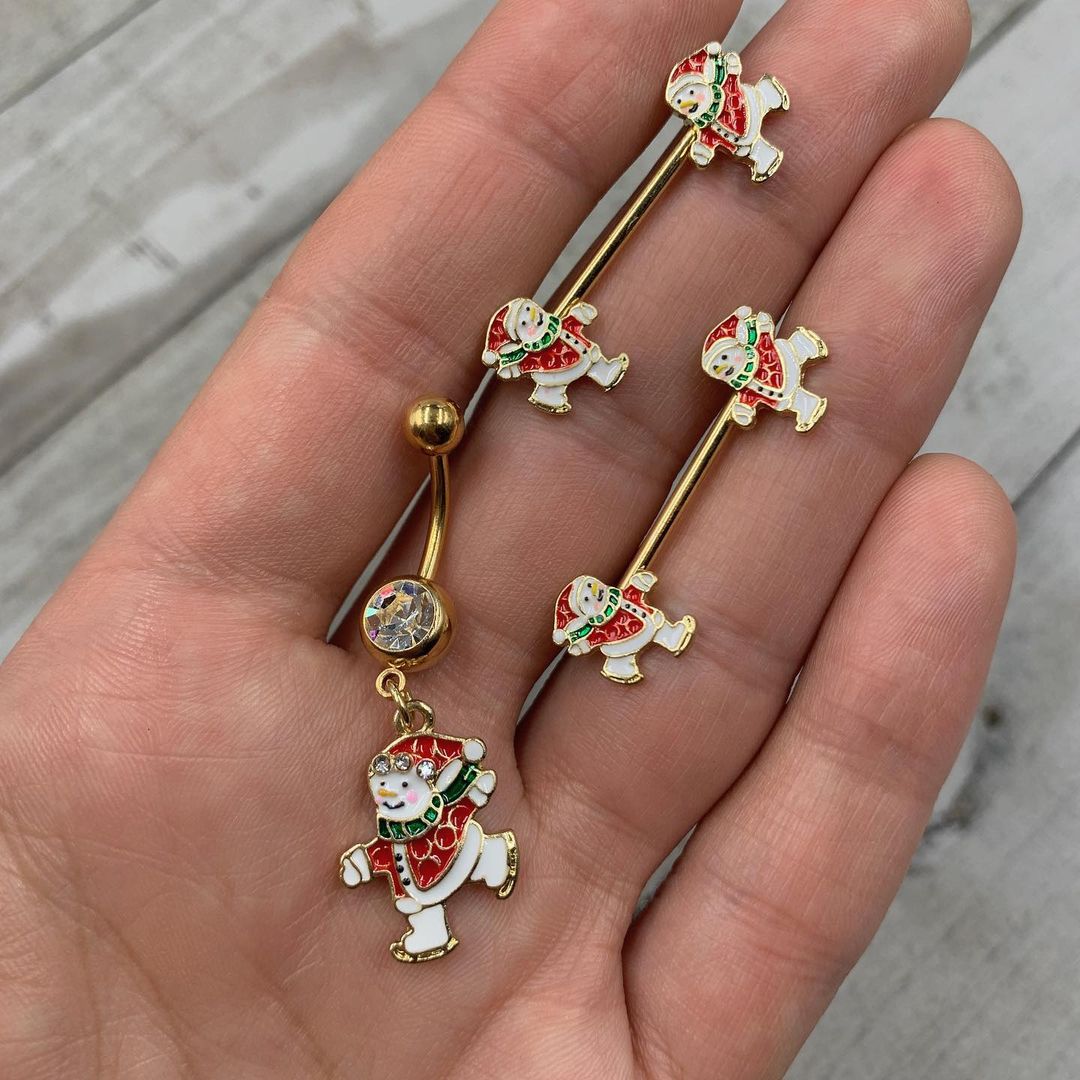 BodyCandy 14G 9/16 Gold Tone Ice Skate Snowman Christmas Nipple Ring Set — detail close-up