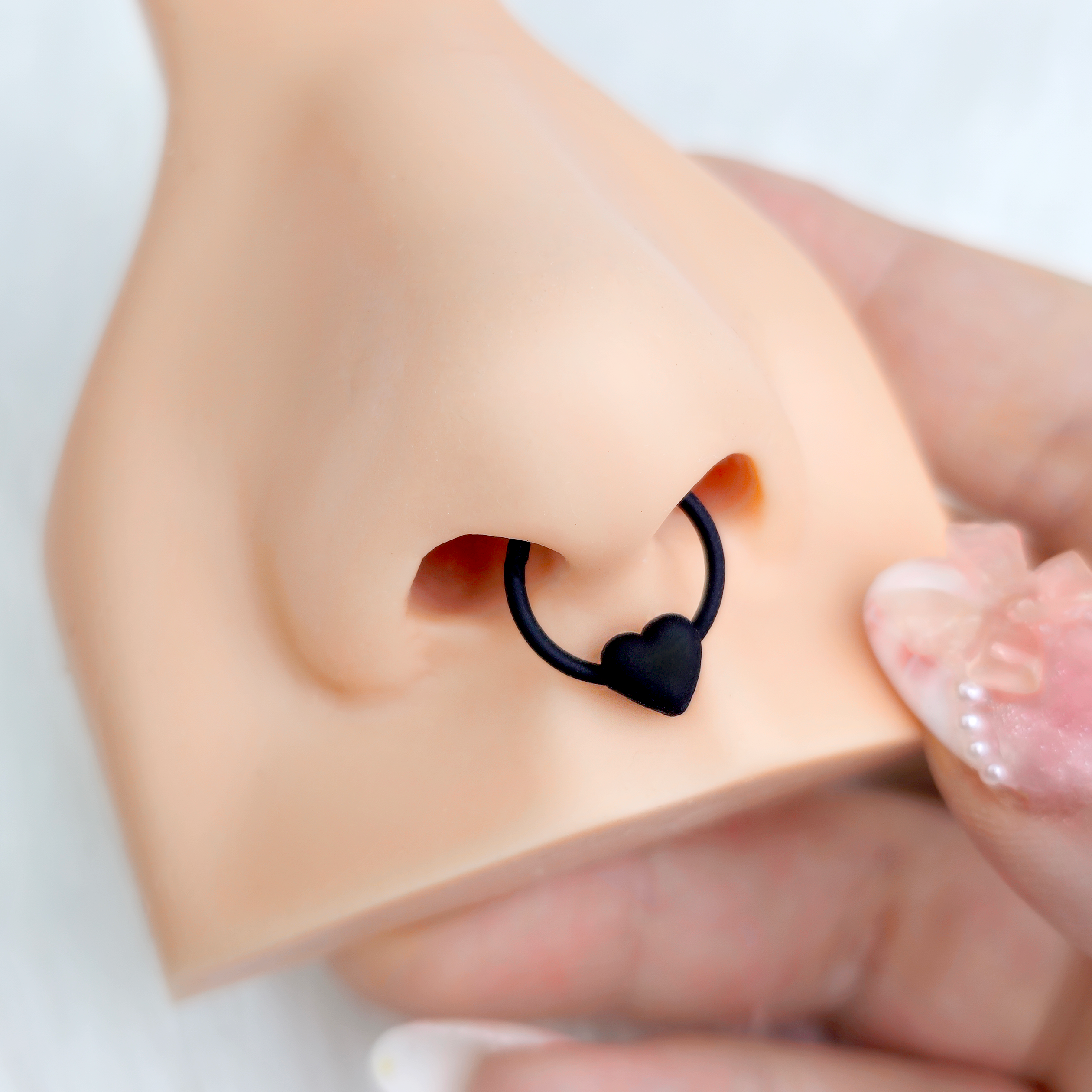 BodyCandy 18G 3/8 Black Matte Little Heart Hinged Segment Ring — detail close-up