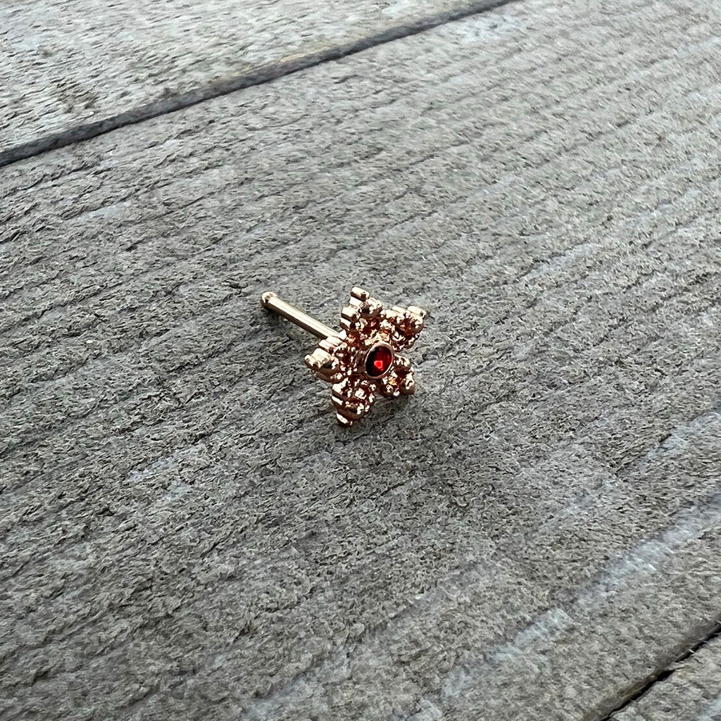 BodyCandy 20G 1/4 Red Gem Rose Gold Tone Textured Snowflake Nose Bone — alternative angle