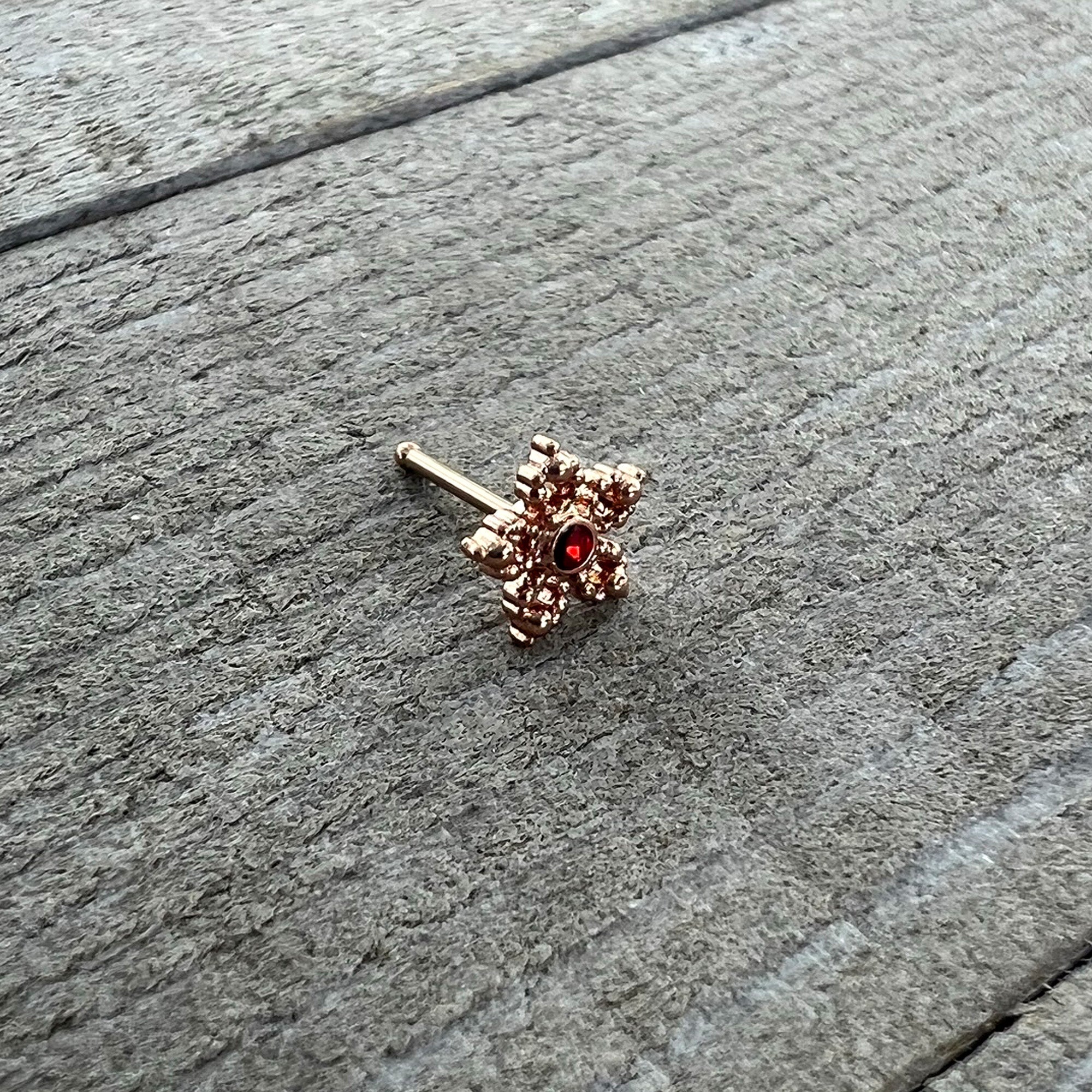 BodyCandy 20G 1/4 Red Gem Rose Gold Tone Textured Snowflake Nose Bone — alternative angle