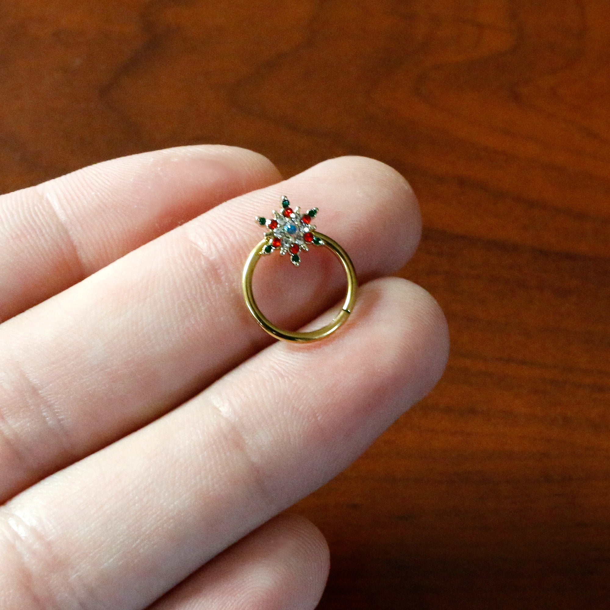 BodyCandy 16G 3/8 Aurora Gem Gold Tone Christmas Star Hinged Segment Ring — in-use photo