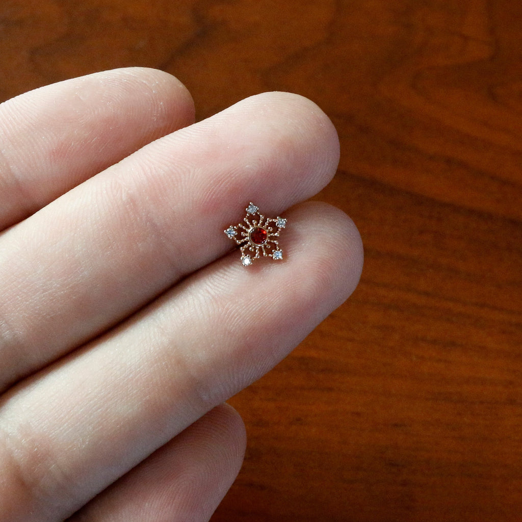 BodyCandy 16G 5/16 Red Gem Rose Gold Tone Texture Snowflake Labret Tragus — in-use photo