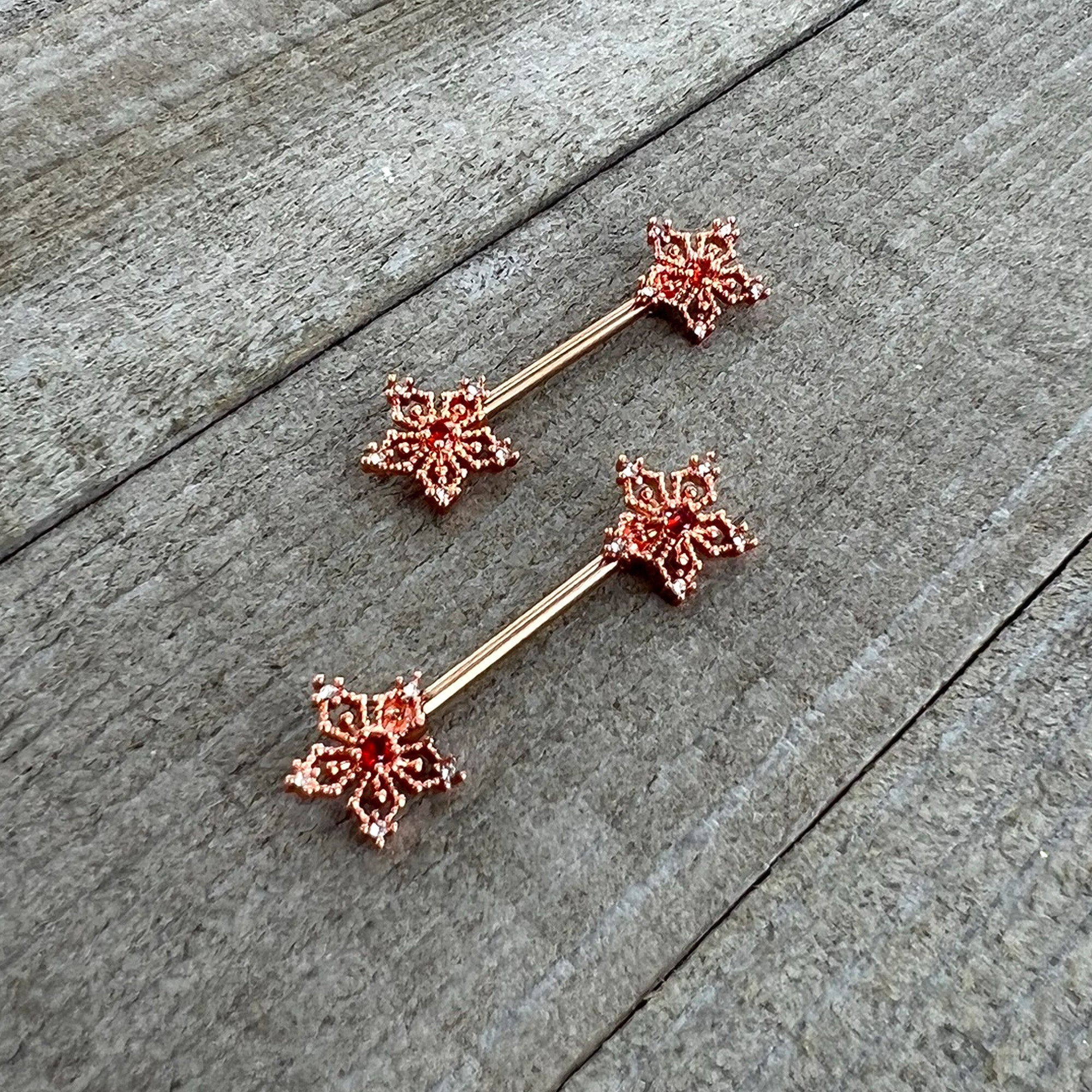 BodyCandy 14G 9/16 Red Gem Rosy Hue Texture Snowflake Barbell Nipple Ring Set — side view