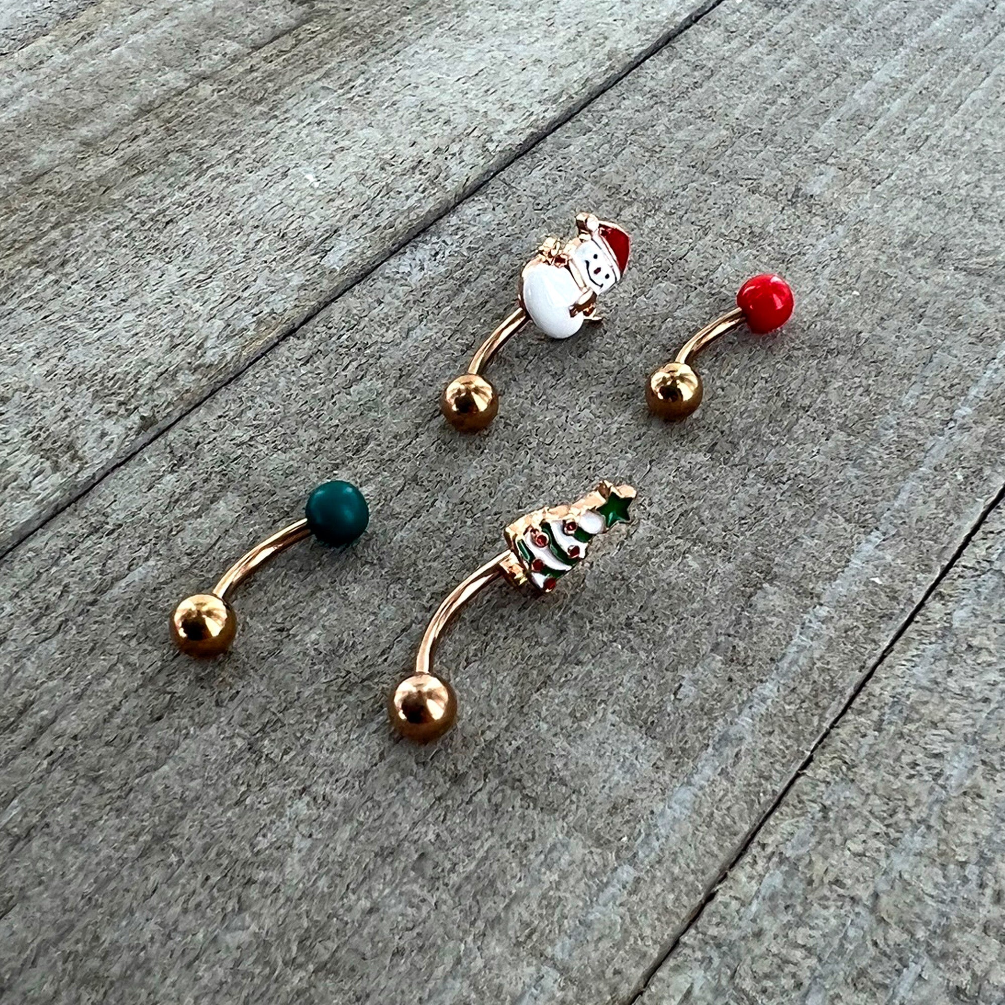 BodyCandy 16G 5/16 Rosy Hue Snowman Christmas Curved Eyebrow Ring Set of 4 — in-use photo