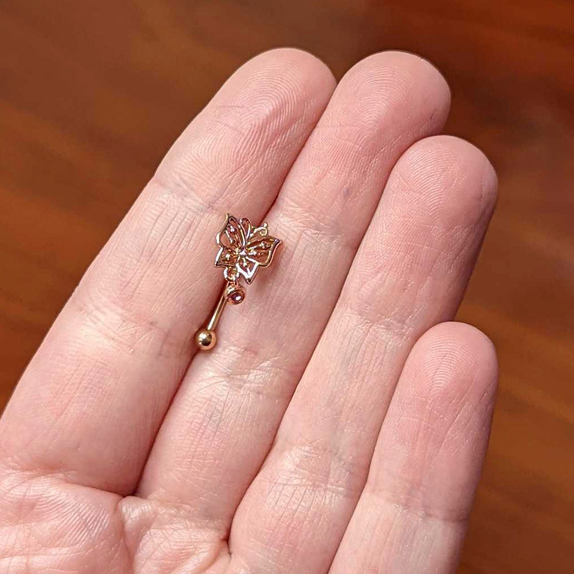 BodyCandy 16G 5/16 Pink CZ Gem Rose Gold Tone Butterfly Curved Eyebrow Ring — lifestyle context