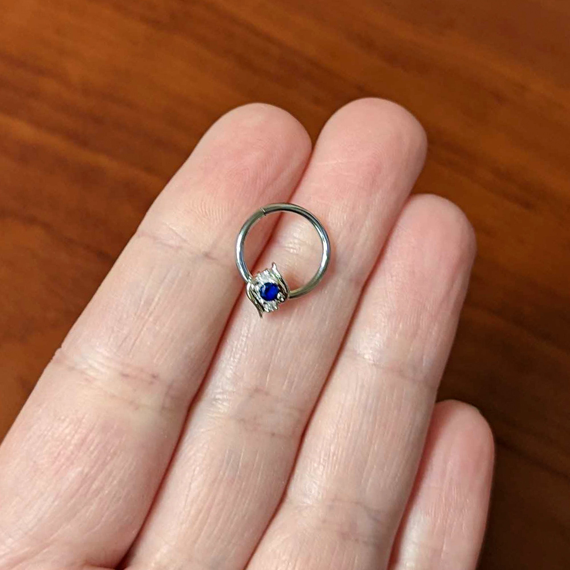 BodyCandy 16G 3/8 Clear Blue Gem Oval Swirl Hinged Segment Ring — side view