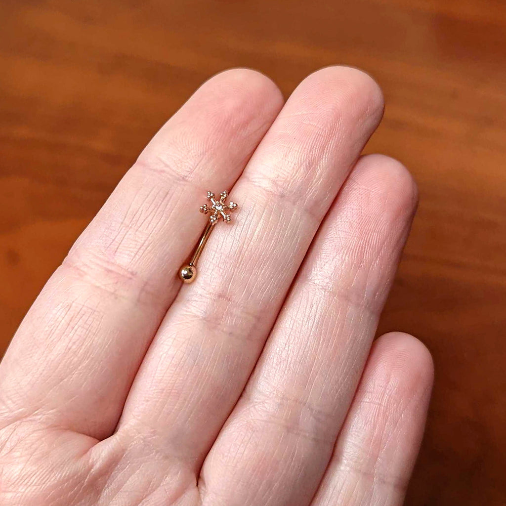 BodyCandy 16G 5/16 Clear Gem Rose Gold Tone Snowflake Curved Eyebrow Ring — lifestyle context