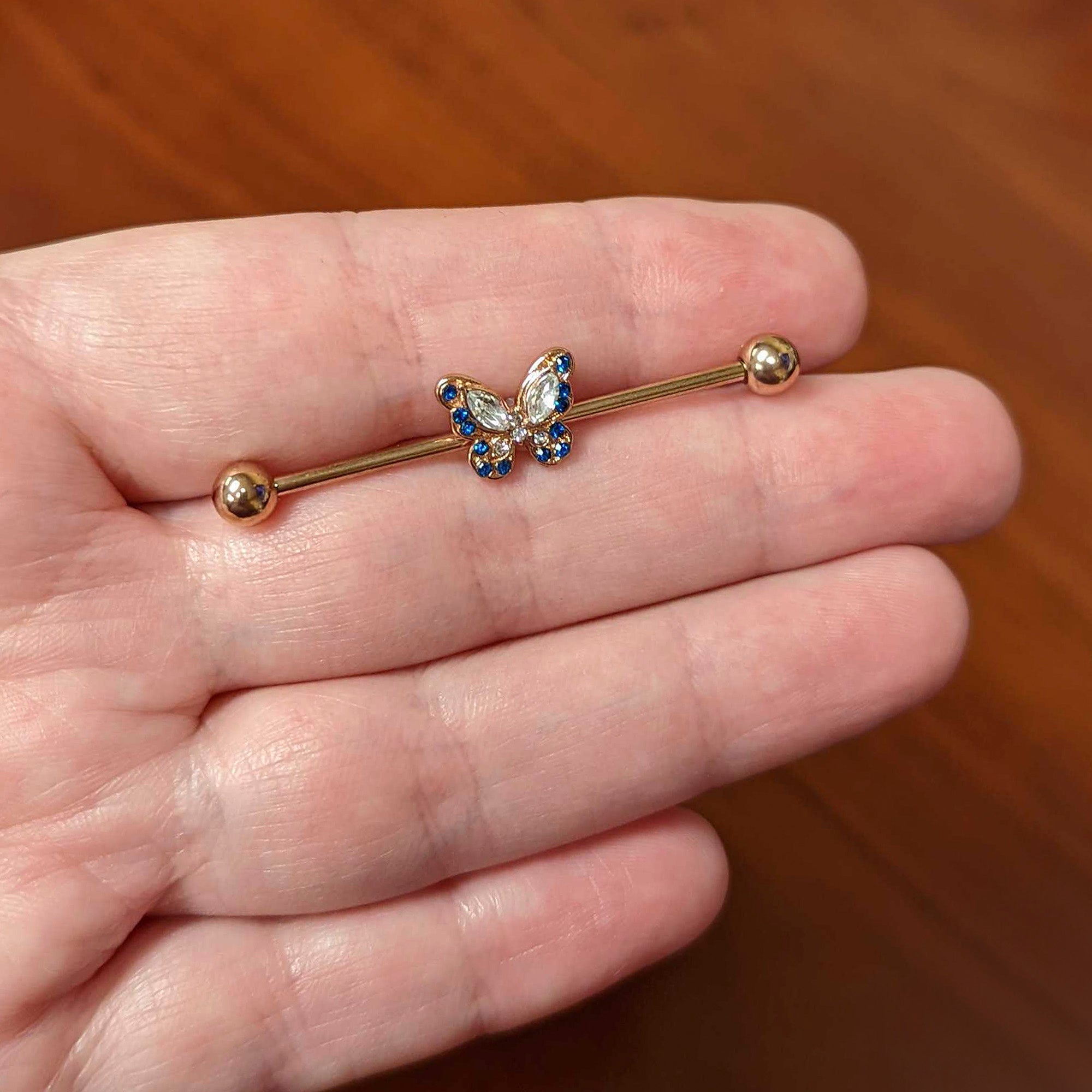 BodyCandy 14G Blue Gem Rosy Tone Butterfly Wings Industrial Barbell 38mm — lifestyle context