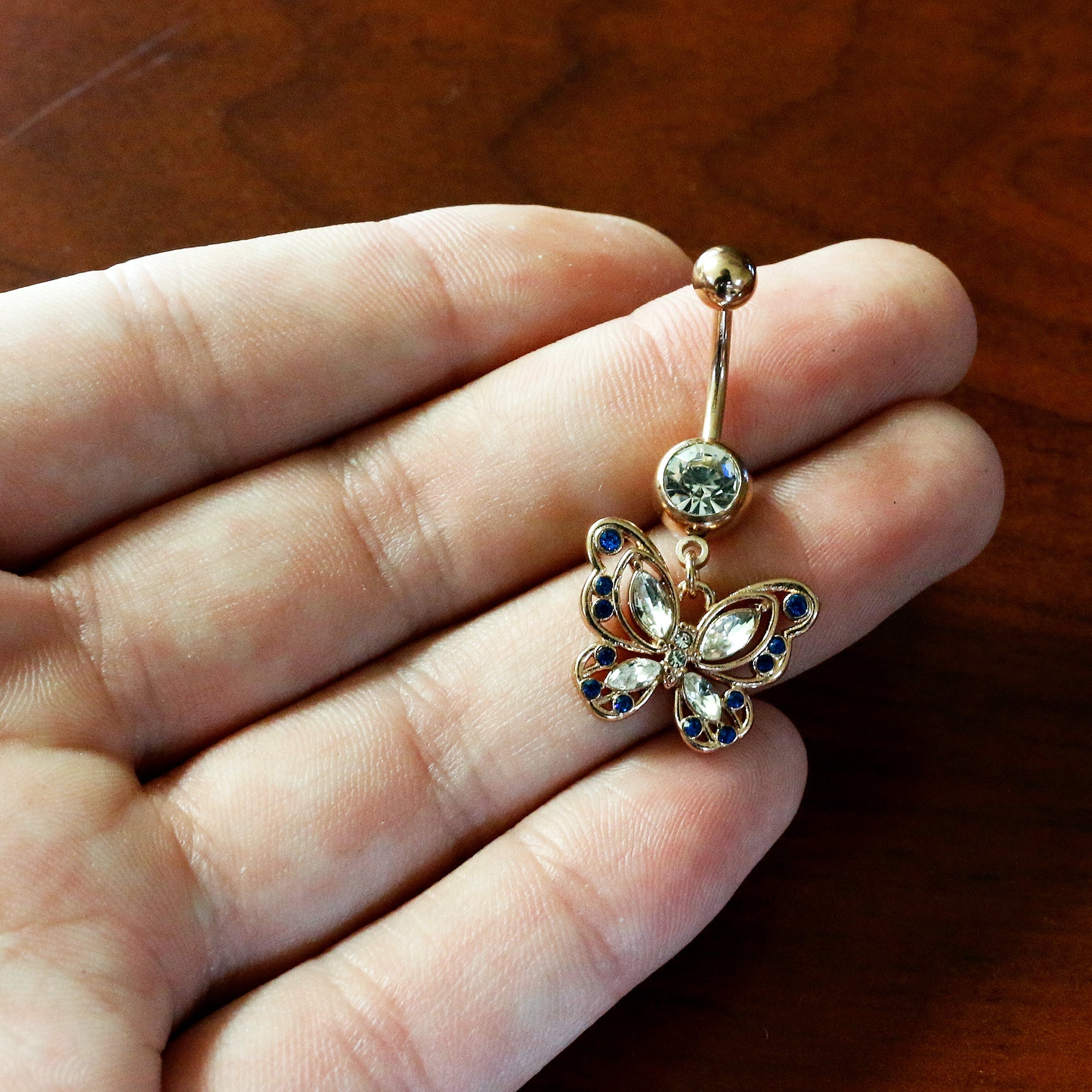 BodyCandy Blue Clear Gem Rose Gold Tone Butterfly Wings Dangle Belly Ring — detail close-up