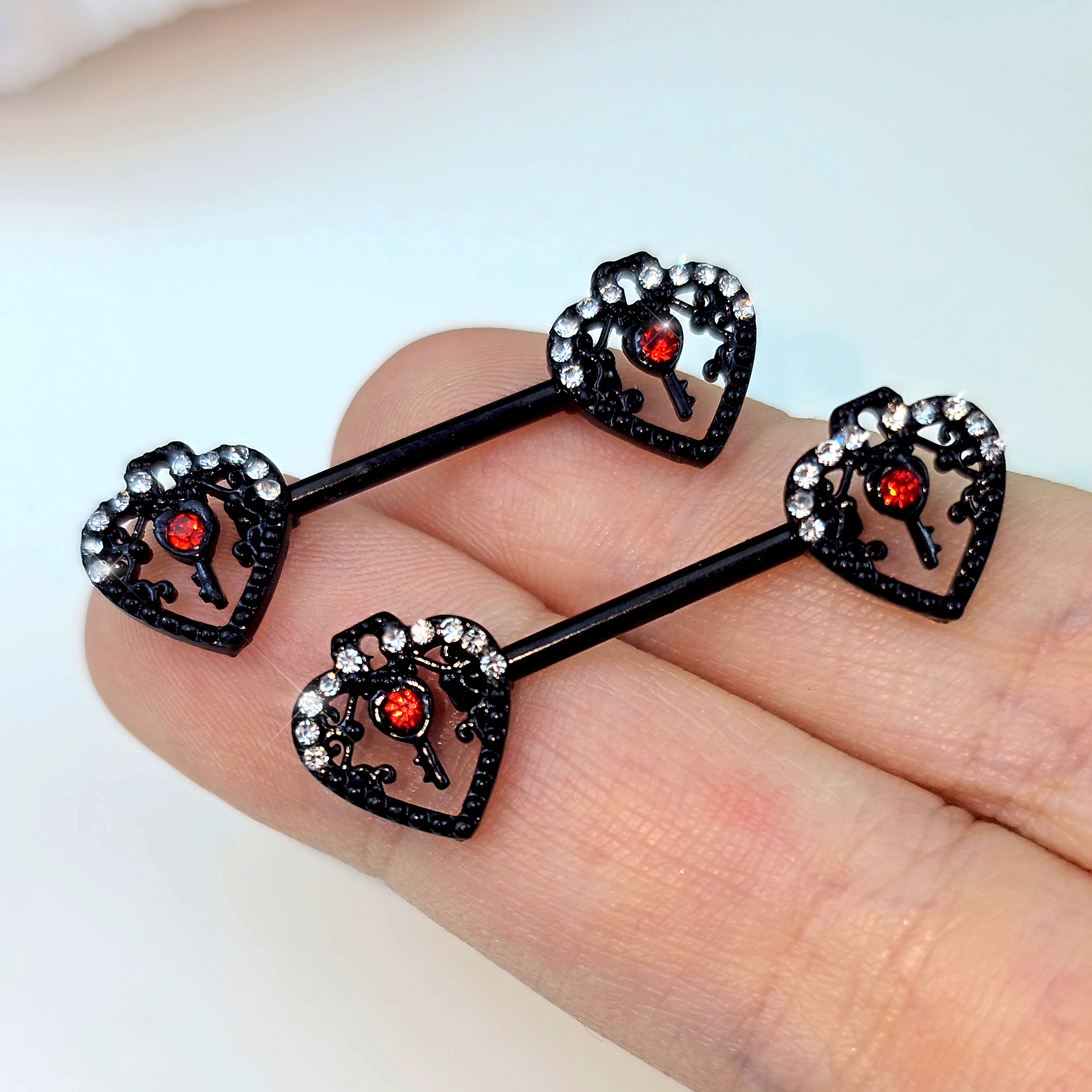 BodyCandy 14G 9/16 Red Clear Gem Black Key Heart Barbell Nipple Ring Set — side view