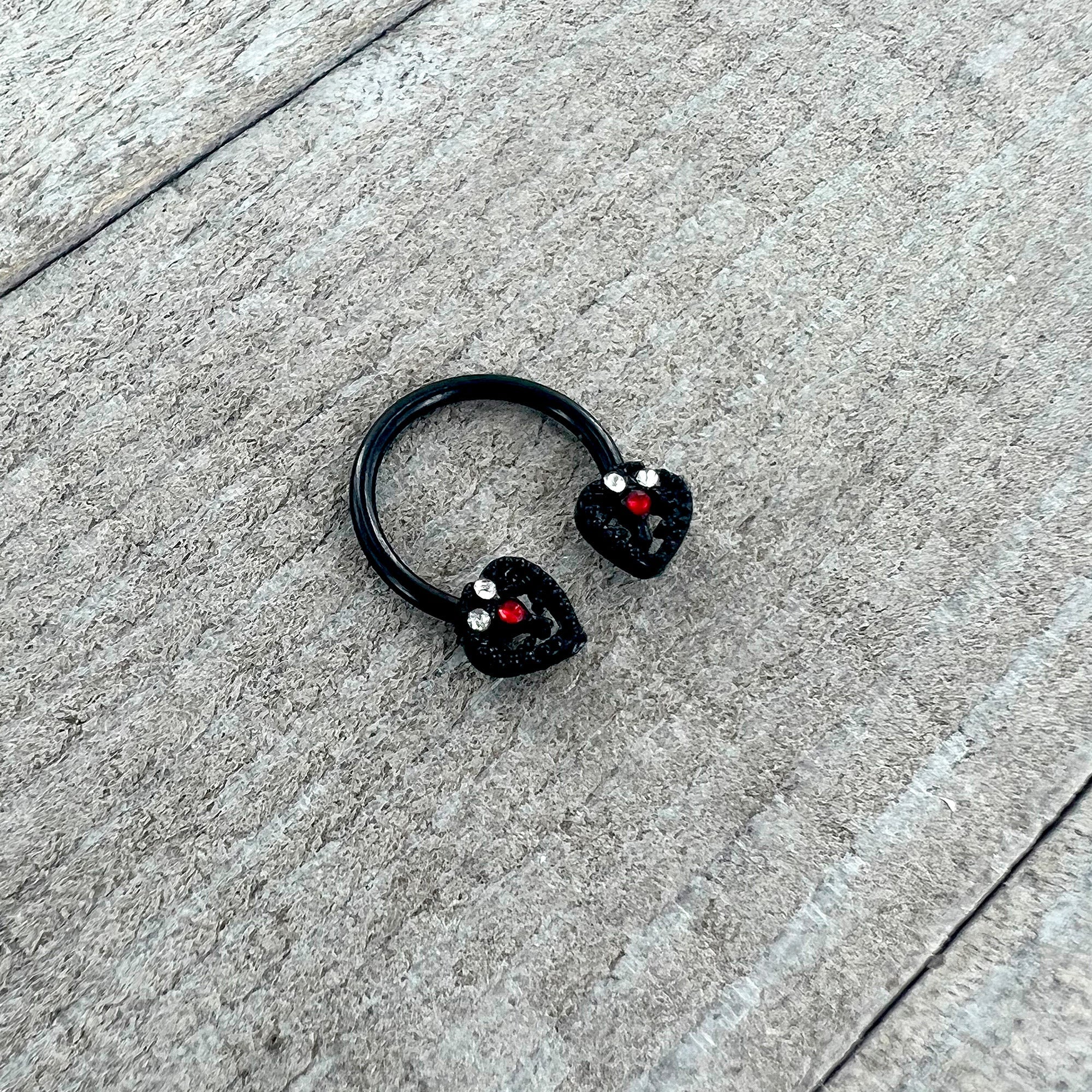 BodyCandy 16G 3/8 Clear Red Gem Black Key Heart Horseshoe Circular Barbell — side view