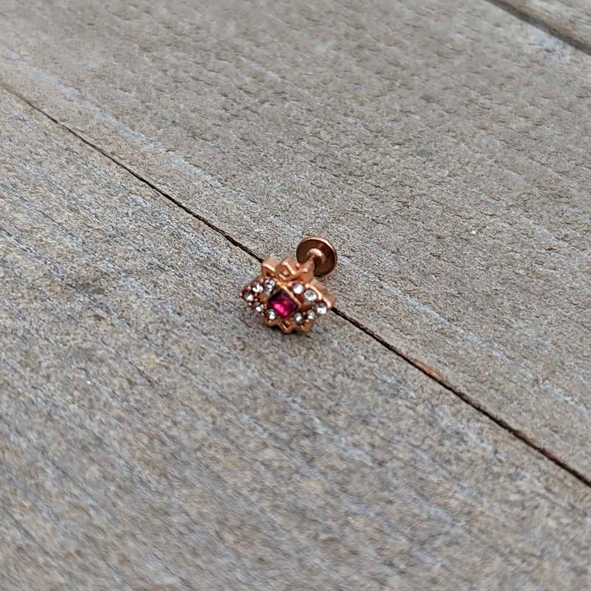 BodyCandy 16G 1/4 Red Gem Rose Gold Tone Octogram Star Labret Monroe Tragus — in-use photo