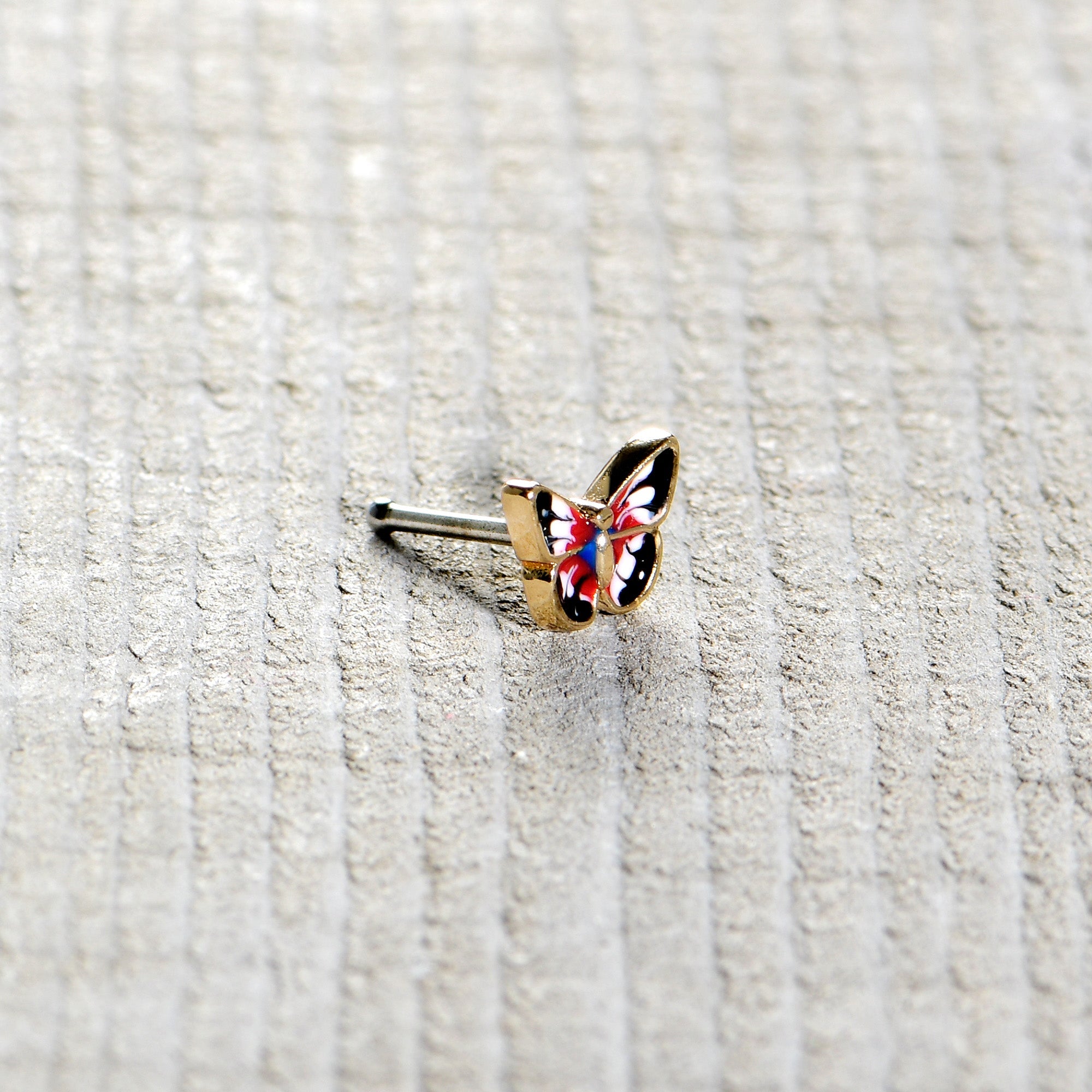 BodyCandy 20G 1/4 Red Blue White Butterfly Nose Bone — in-use photo