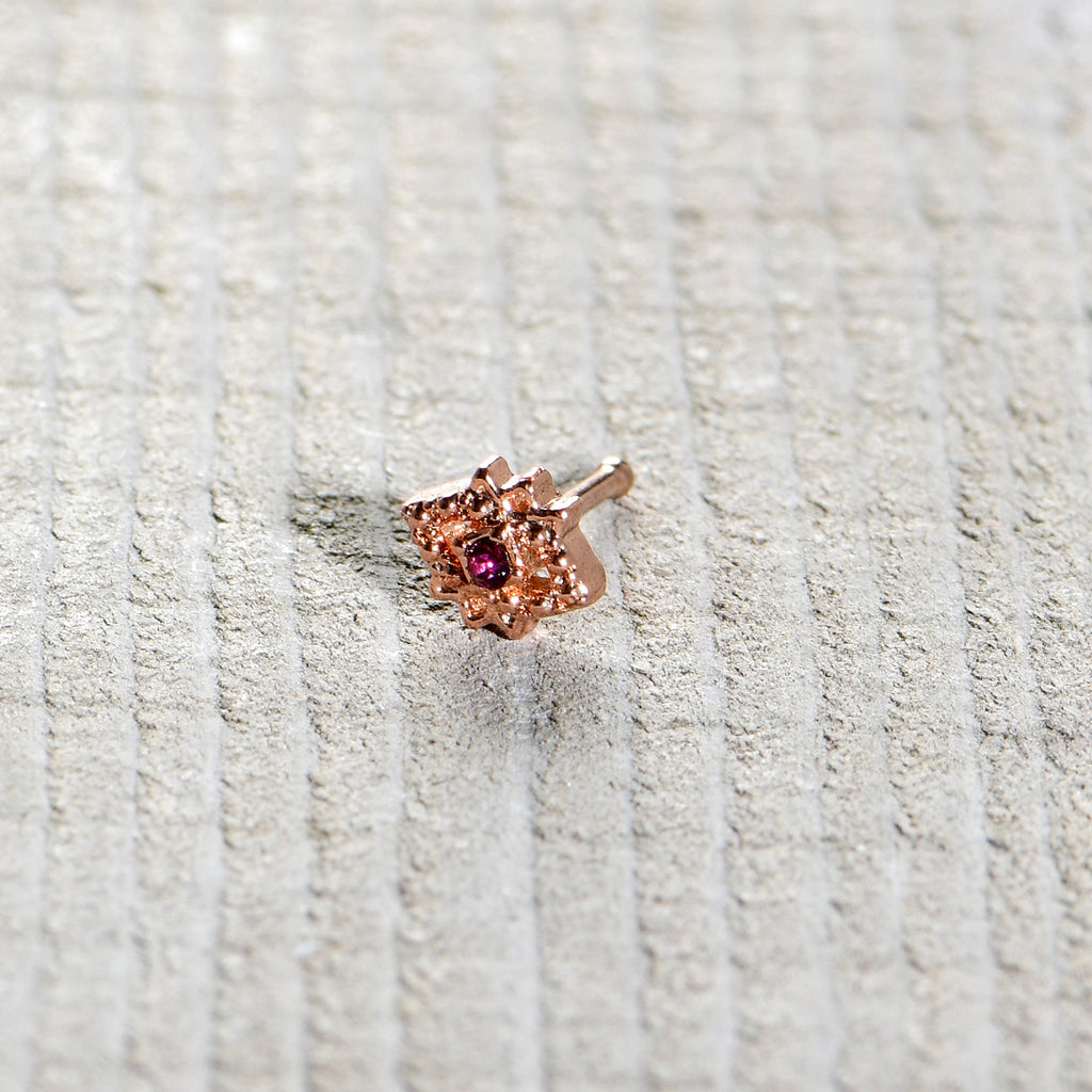 BodyCandy 20G 1/4 Red Gem Rose Gold Tone Octogram Star Nose Bone — in-use photo