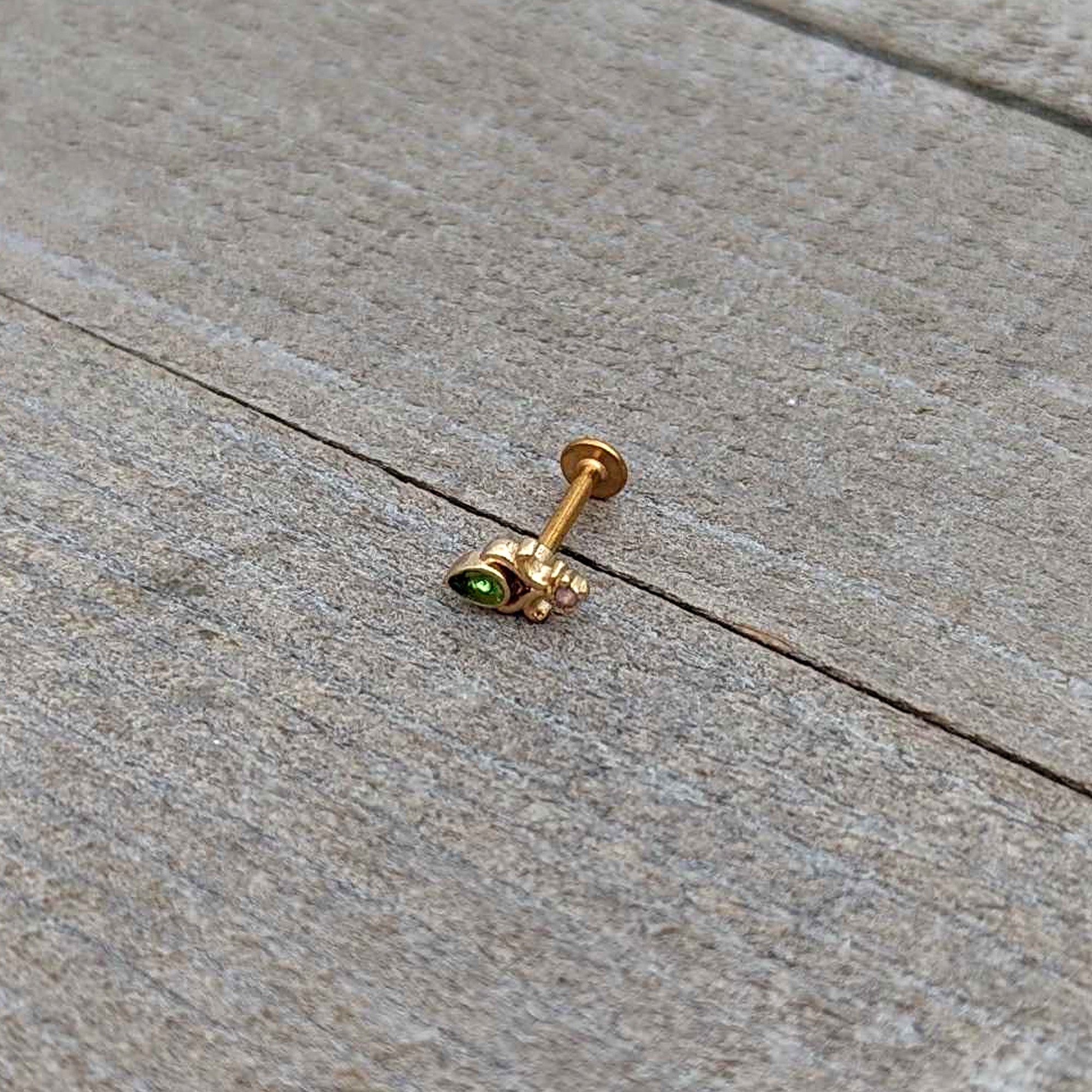 BodyCandy 16G 5/16 Green Gem Gold Tone Shades of Spring Labret Monroe Tragus — in-use photo