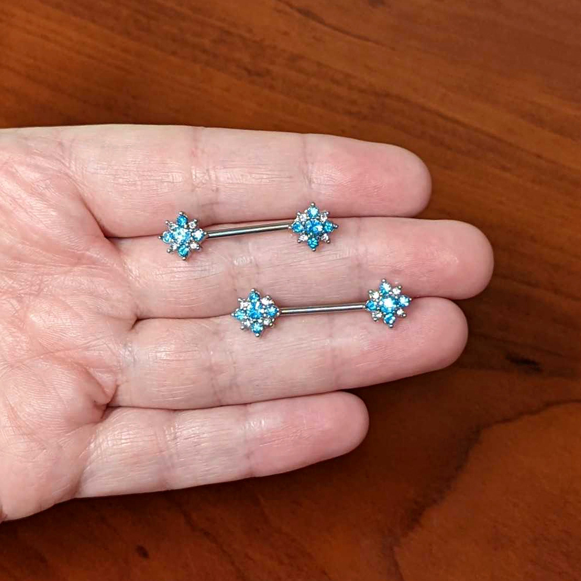 BodyCandy 14G 9/16 Clear Blue Gem Opulent Flower Barbell Nipple Ring Set — side view