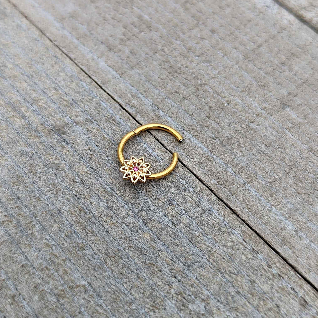 BodyCandy 16G 3/8 Pink Gem Gold Tone Starry Flower Hinged Segment Ring — in-use photo