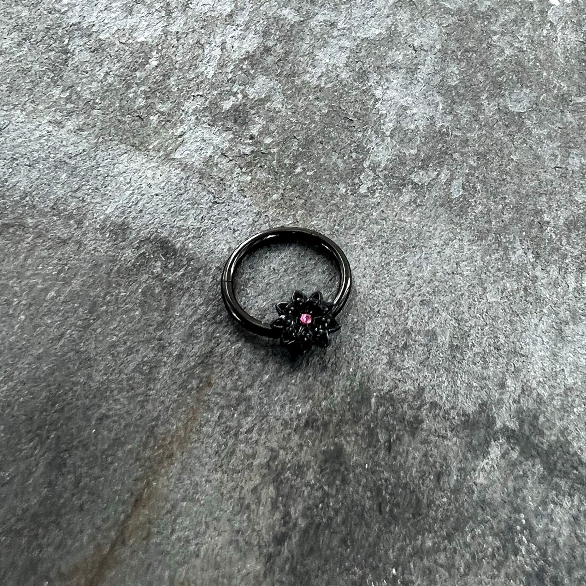 BodyCandy 16G 3/8 Pink Gem Black Starry Flower Hinged Segment Ring — side view