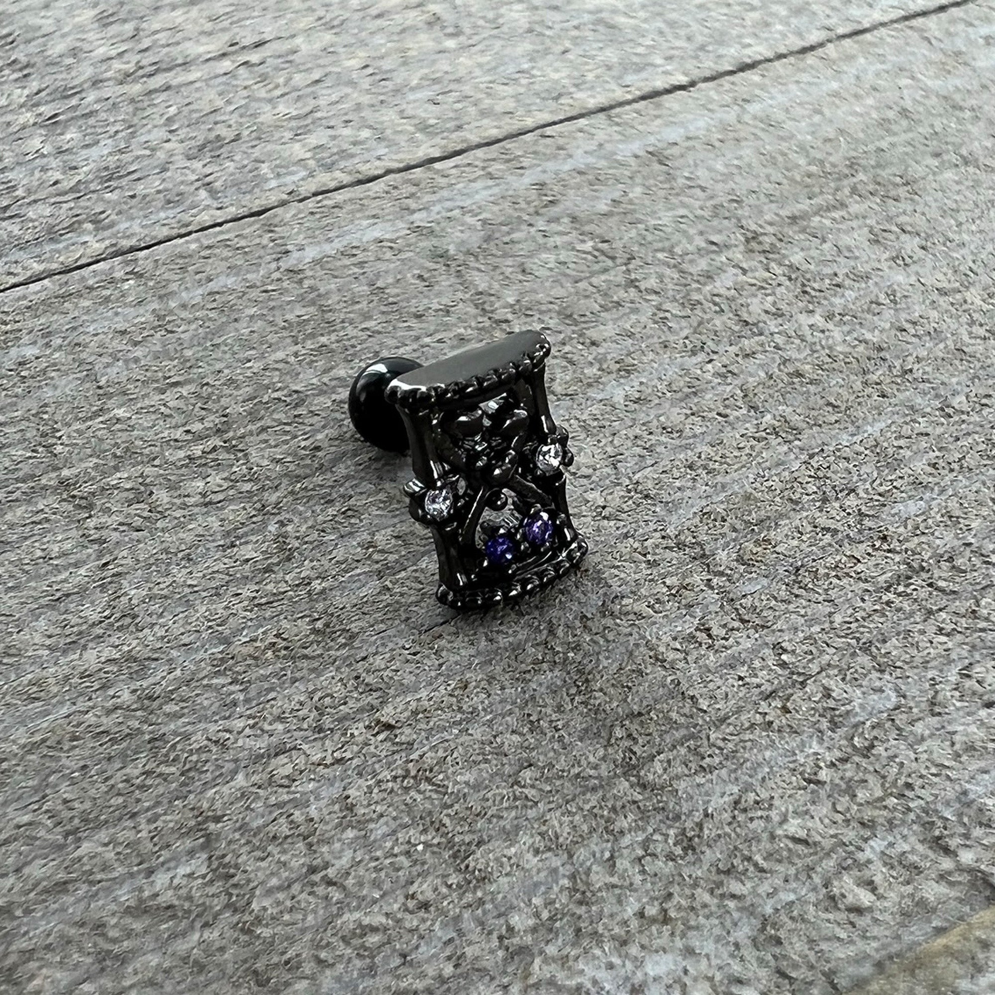 BodyCandy 16G 1/4 Purple Gem Black Gothic Hourglass Cartilage Tragus Earring — in-use photo
