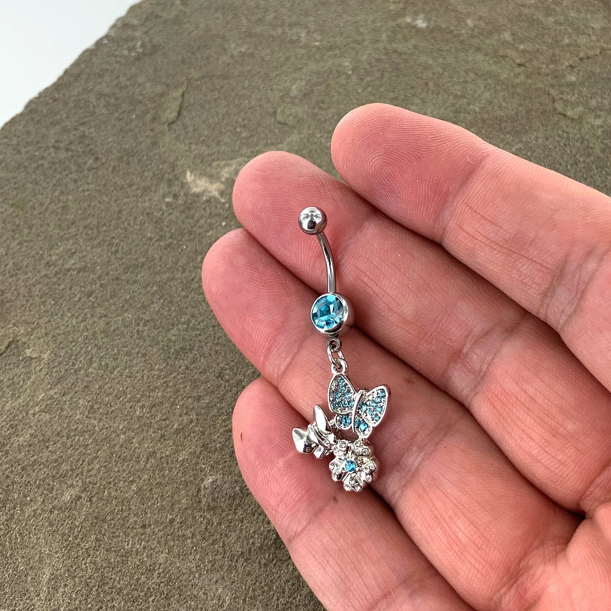 BodyCandy Blue Gem Butterflies Tiny Flower Dangle Belly Ring — side view