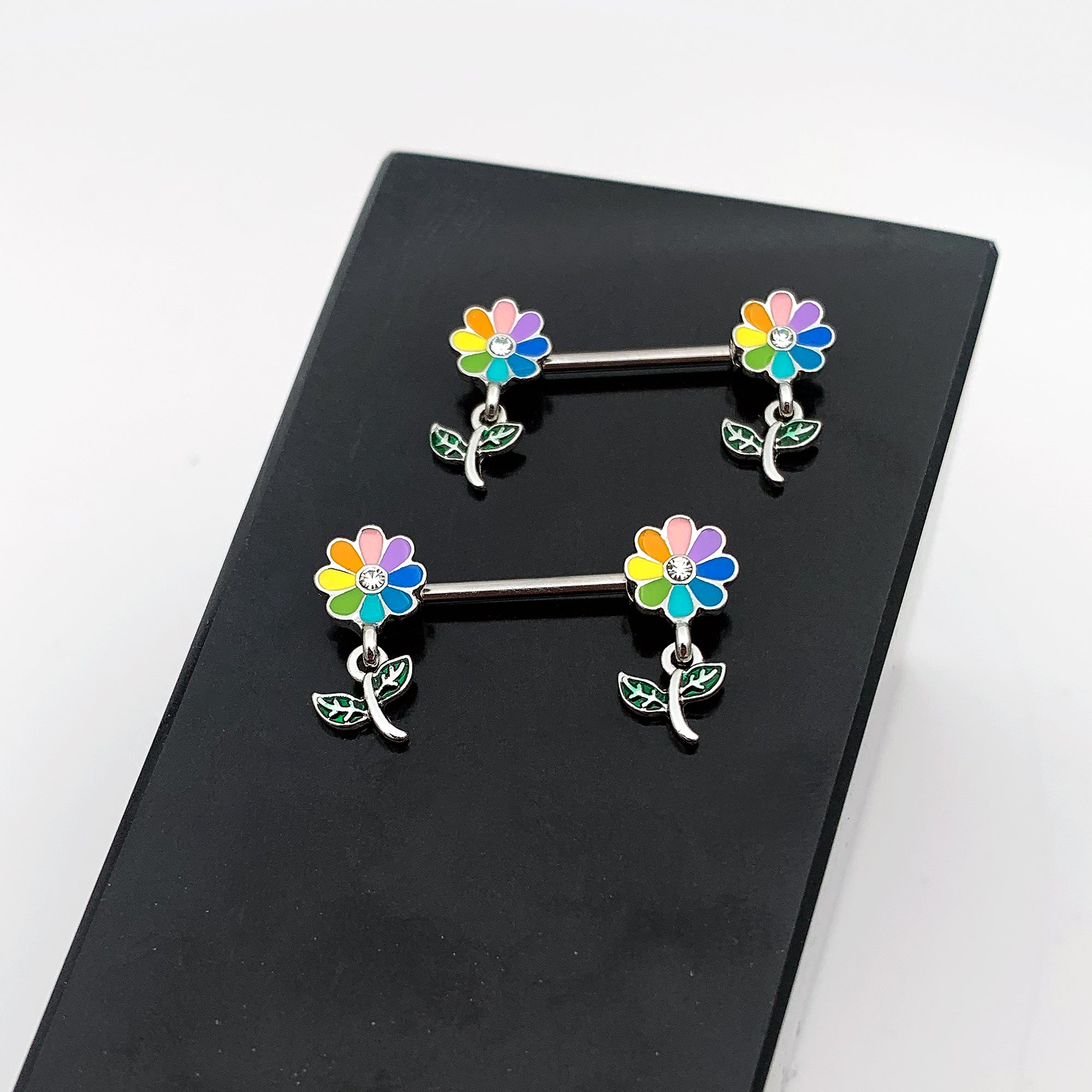 BodyCandy 14G 9/16 Clear Gem Pride Rainbow Flower Dangle Nipple Ring Set — in-use photo