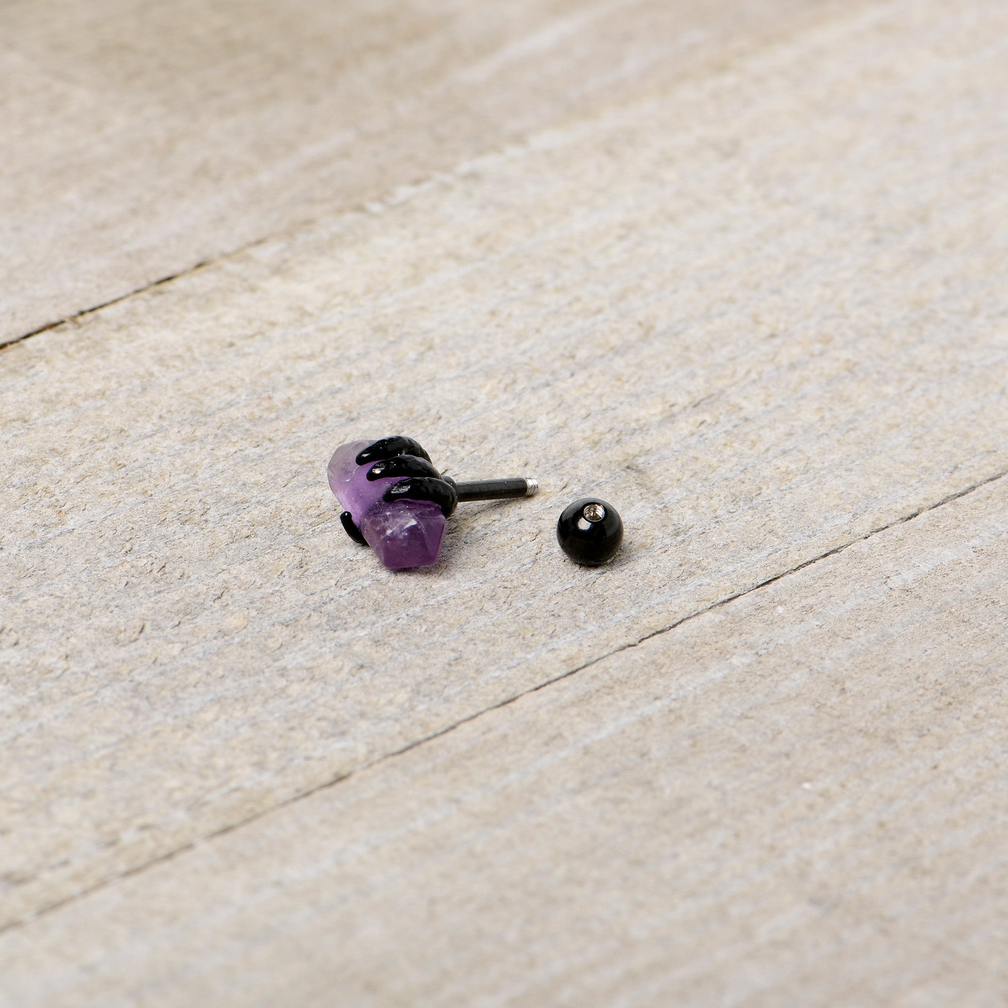 BodyCandy 16G 1/4 Purple Amethyst Black Claw Obelisk Cartilage Earring — in-use photo