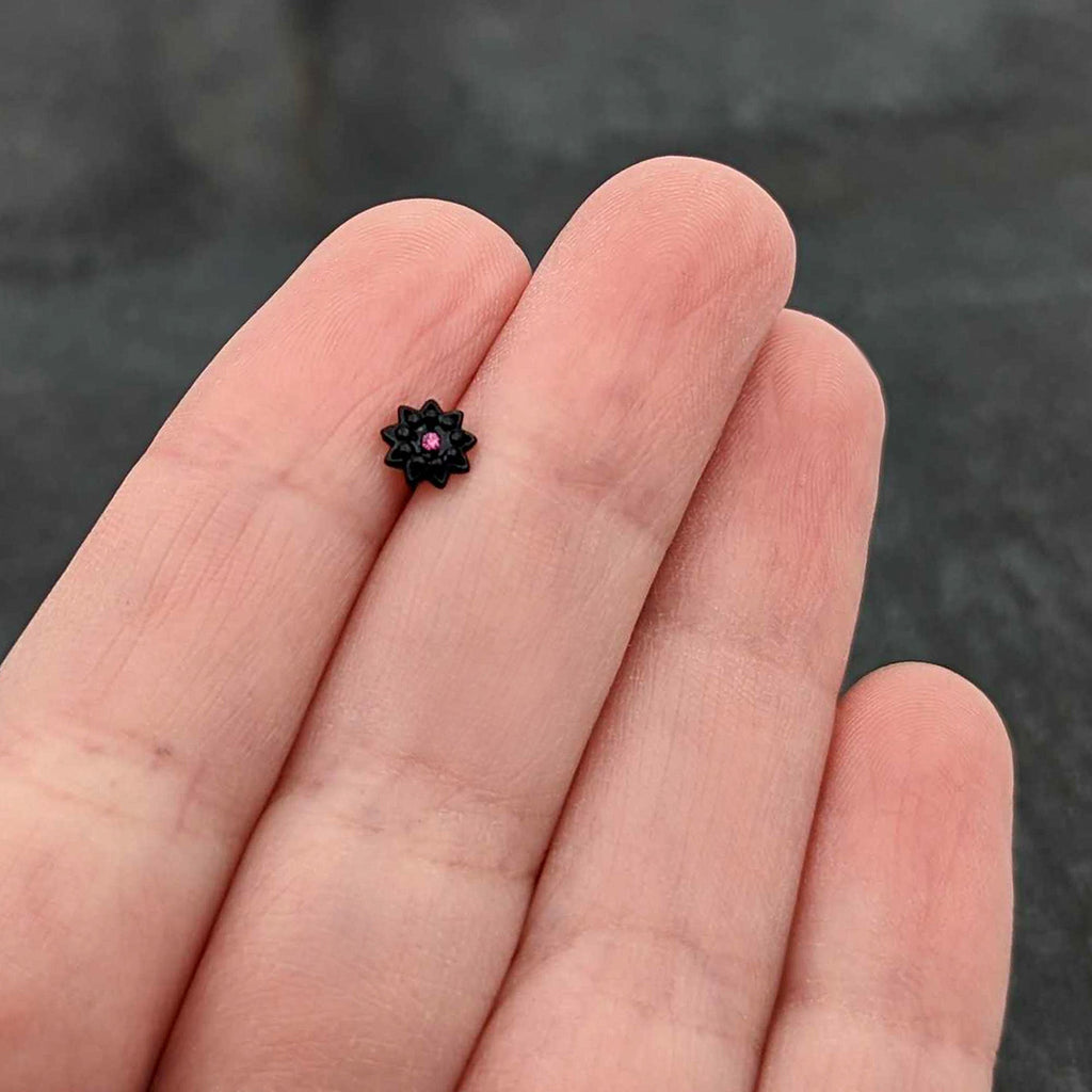 BodyCandy 20G 1/4 Pink Gem Black Starry Flower Halloween Nose Bone — in-use photo