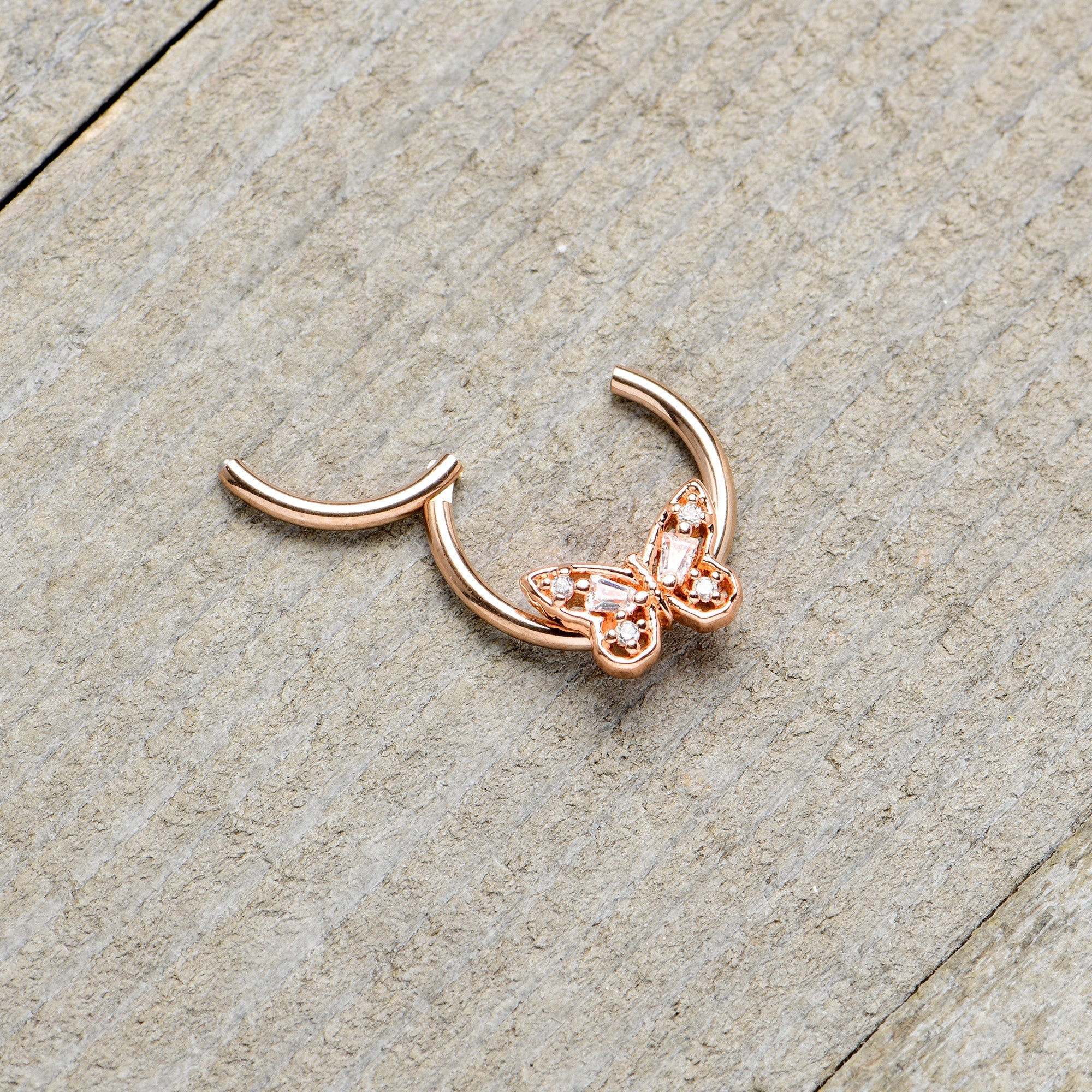 BodyCandy 16G 3/8 Clear Gem Rosy Tone Baroque Butterfly Hinged Segment Ring — in-use photo
