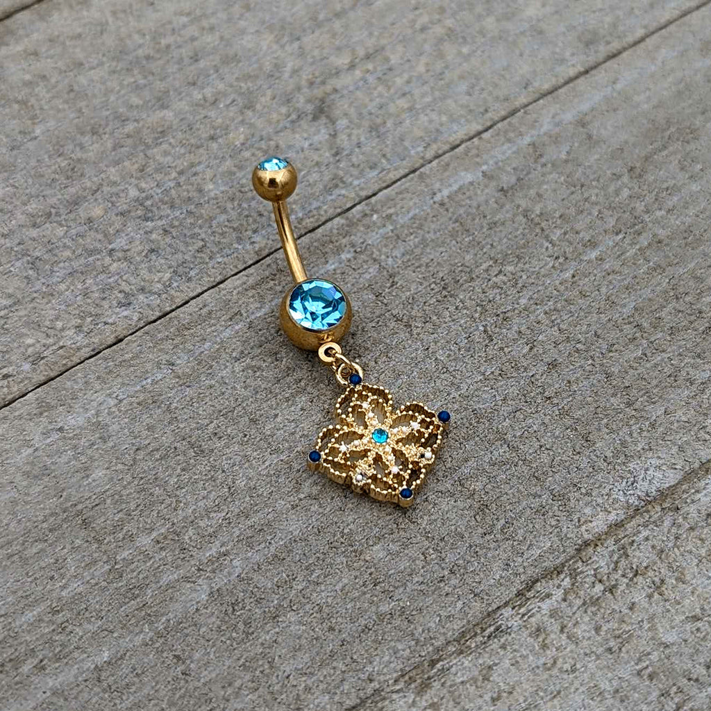 BodyCandy Blue Gem Gold Tone Texture Emblem Dangle Belly Ring — back view