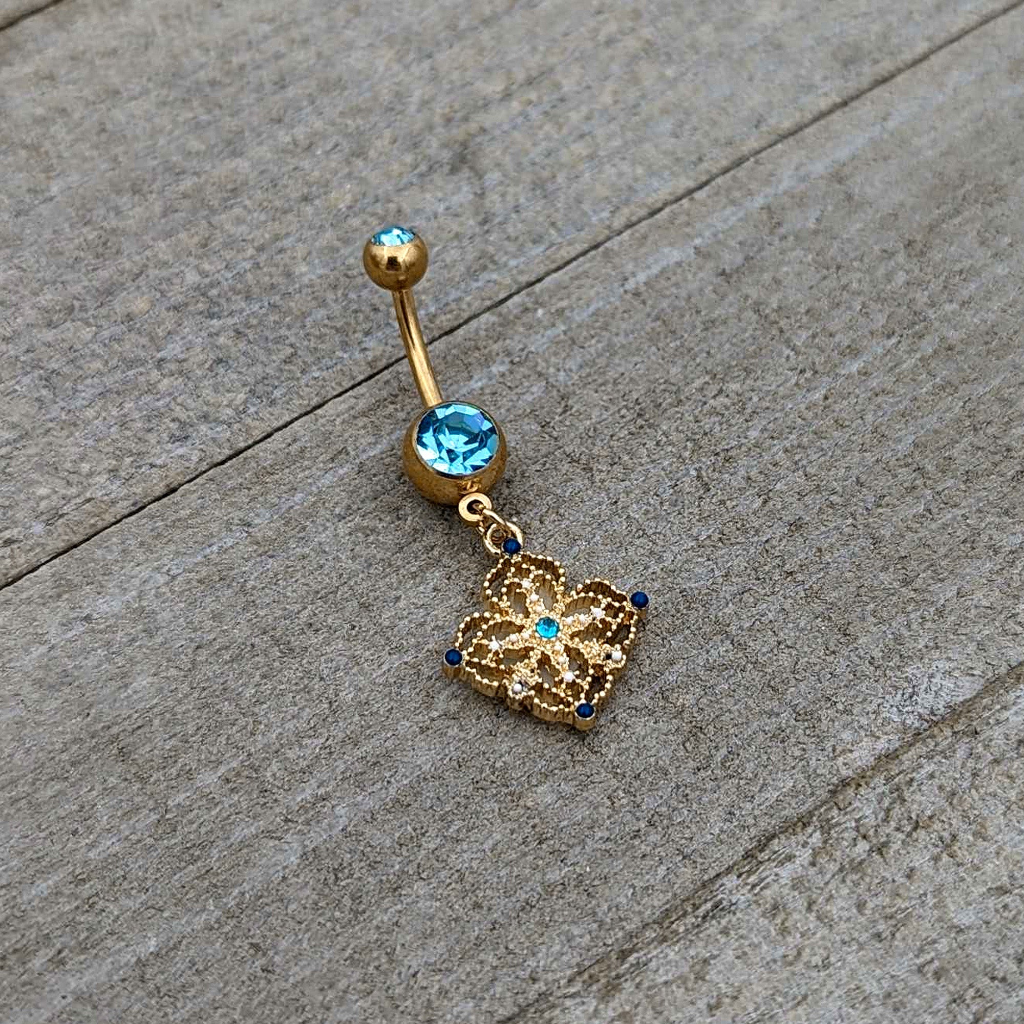 BodyCandy Blue Gem Gold Tone Texture Emblem Dangle Belly Ring — back view
