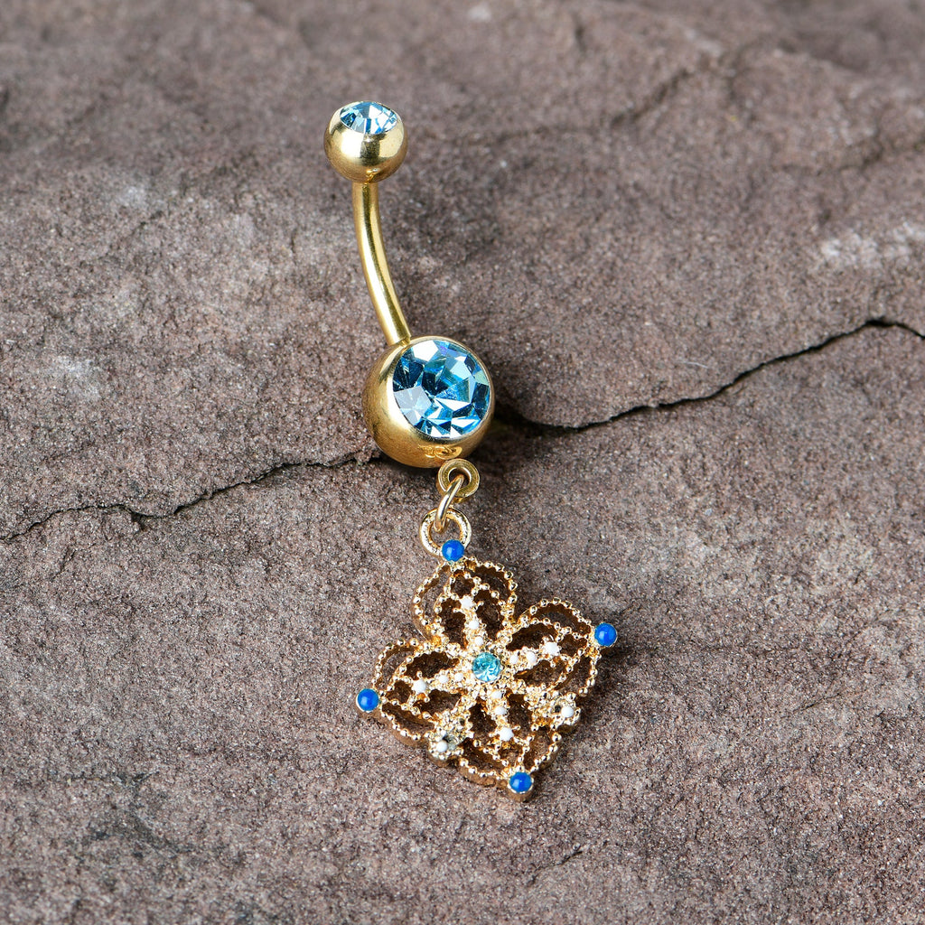 BodyCandy Blue Gem Gold Tone Texture Emblem Dangle Belly Ring — in-use photo