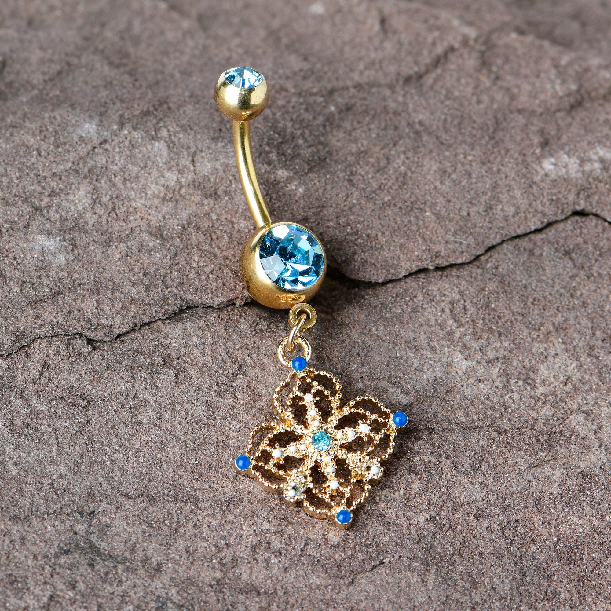 BodyCandy Blue Gem Gold Tone Texture Emblem Dangle Belly Ring — in-use photo