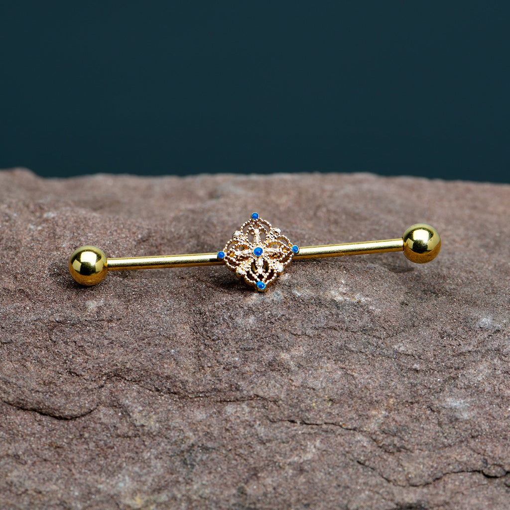 BodyCandy 14G Blue Gem Gold Tone Texture Emblem Industrial Barbell 38mm — in-use photo